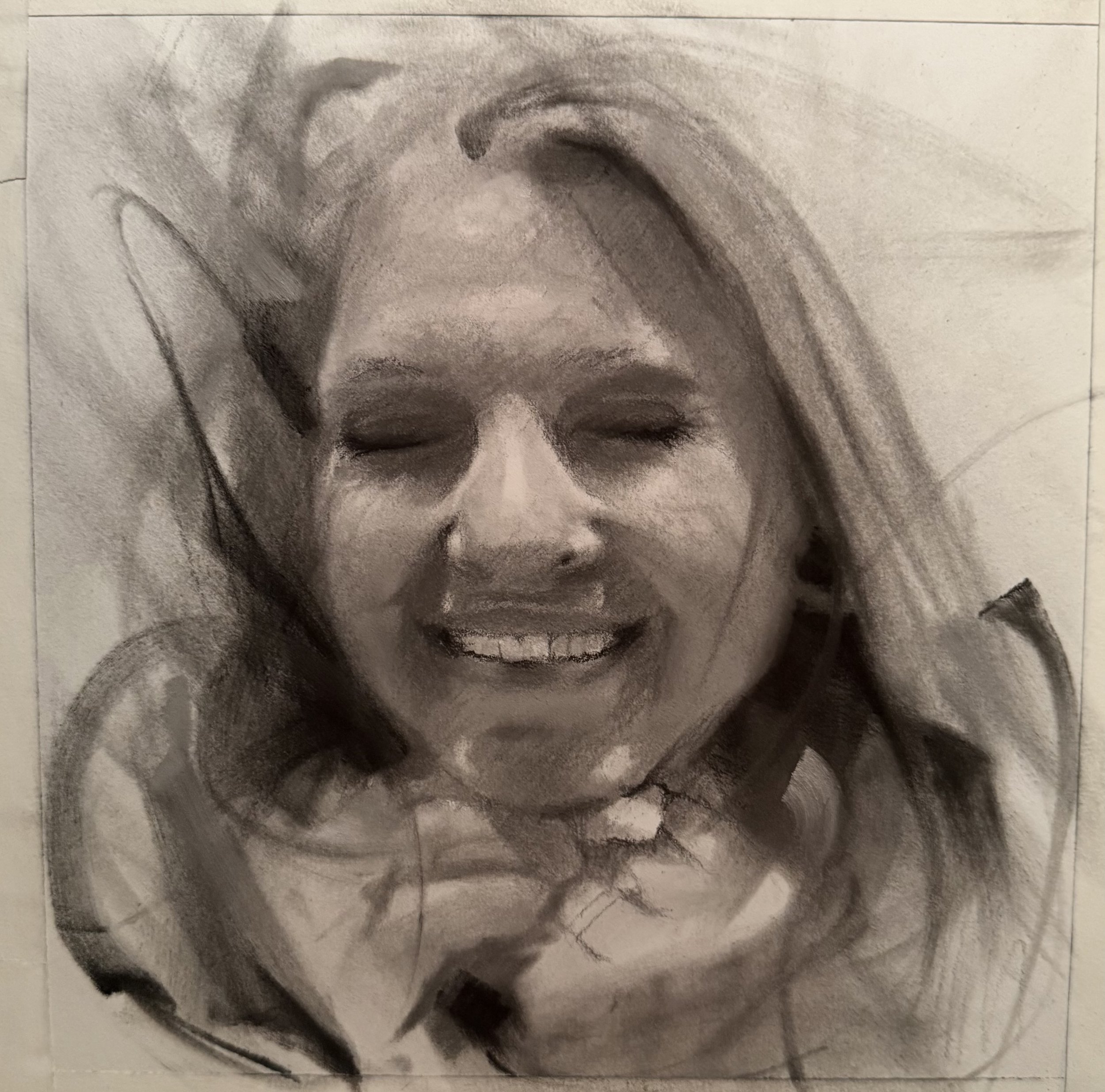 Close-up of a pencil sketch of a smiling woman with closed eyes, long wavy hair, and delicate facial features.