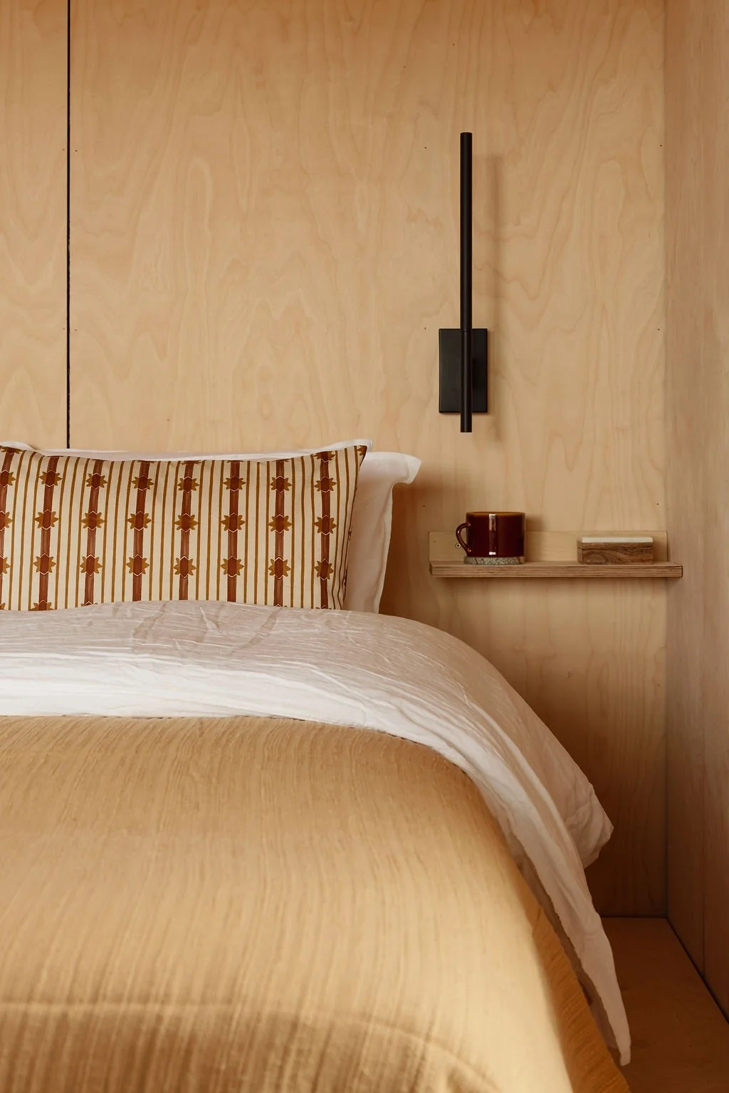 Mustard bedding on king-sized bed. With touch lamp.