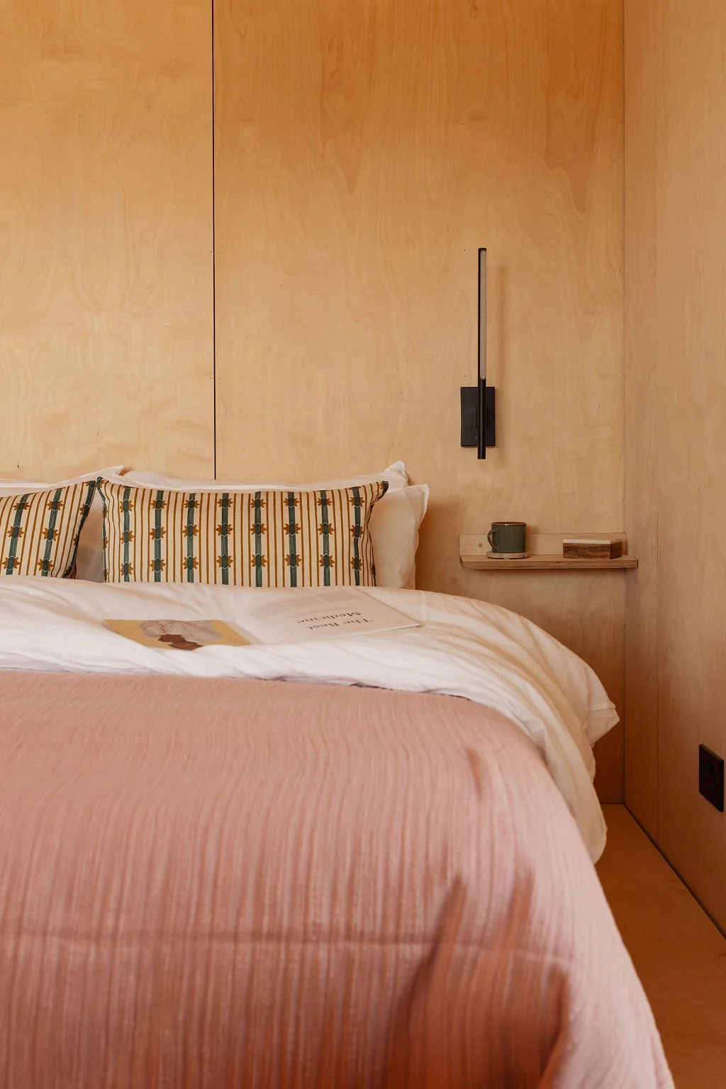 Layered bedding on linen sheets. King-sized bed with Emma mattress. Touch lamp with USB C charging point.