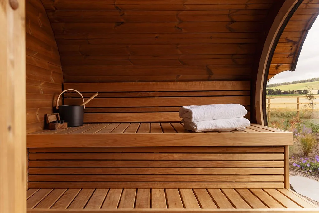 Sauna with bucket and towels.