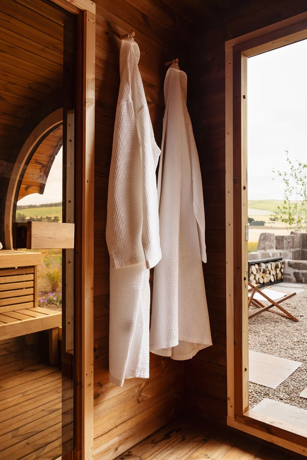 Sauna with robes hanging up. 