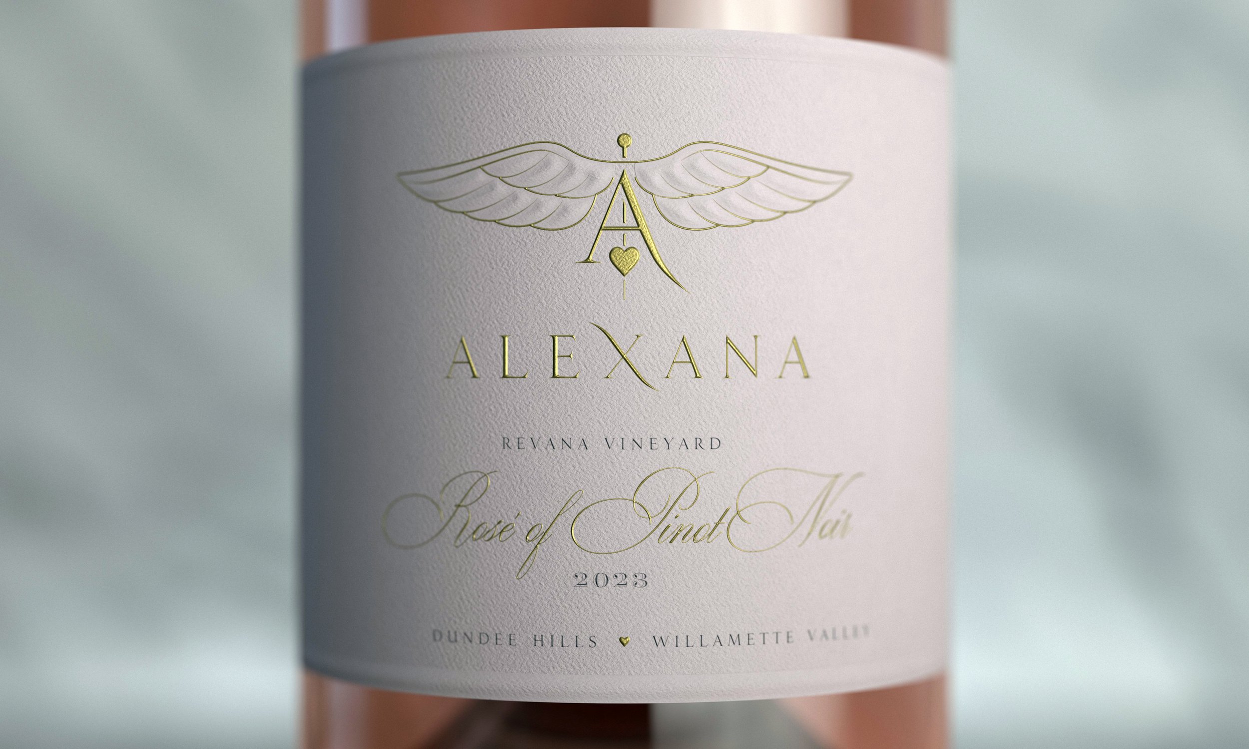 Close-up of a wine bottle label with gold foil and elegant script, reading "Alexana" at the top, with additional details including "Reyana Vineyard", "Rosé of Pinot Noir", 2023, and location "Dundee Hills, Willamette Valley".