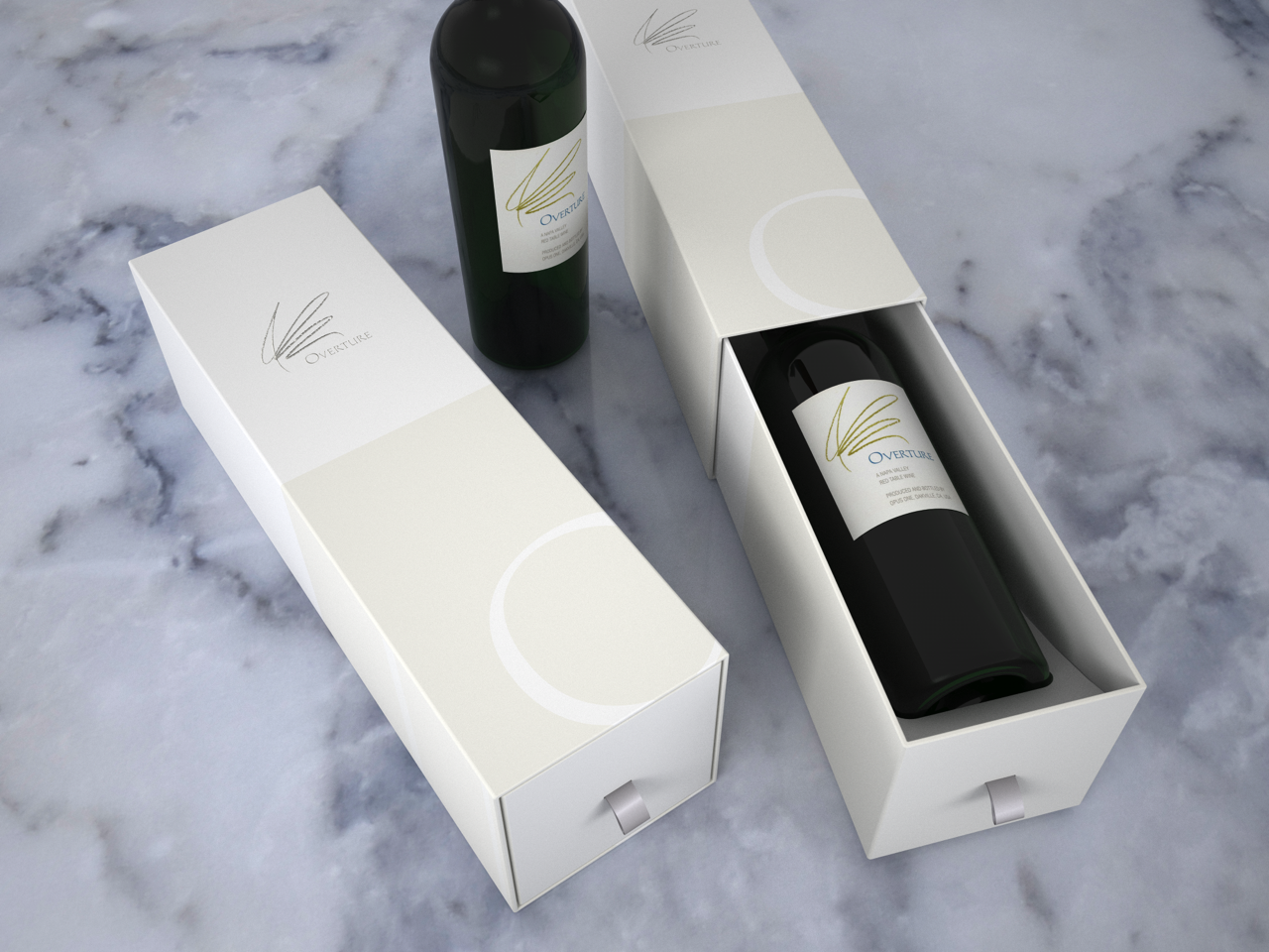 Two white boxes with wine bottles, one open showing a dark wine bottle inside, on a marble surface.