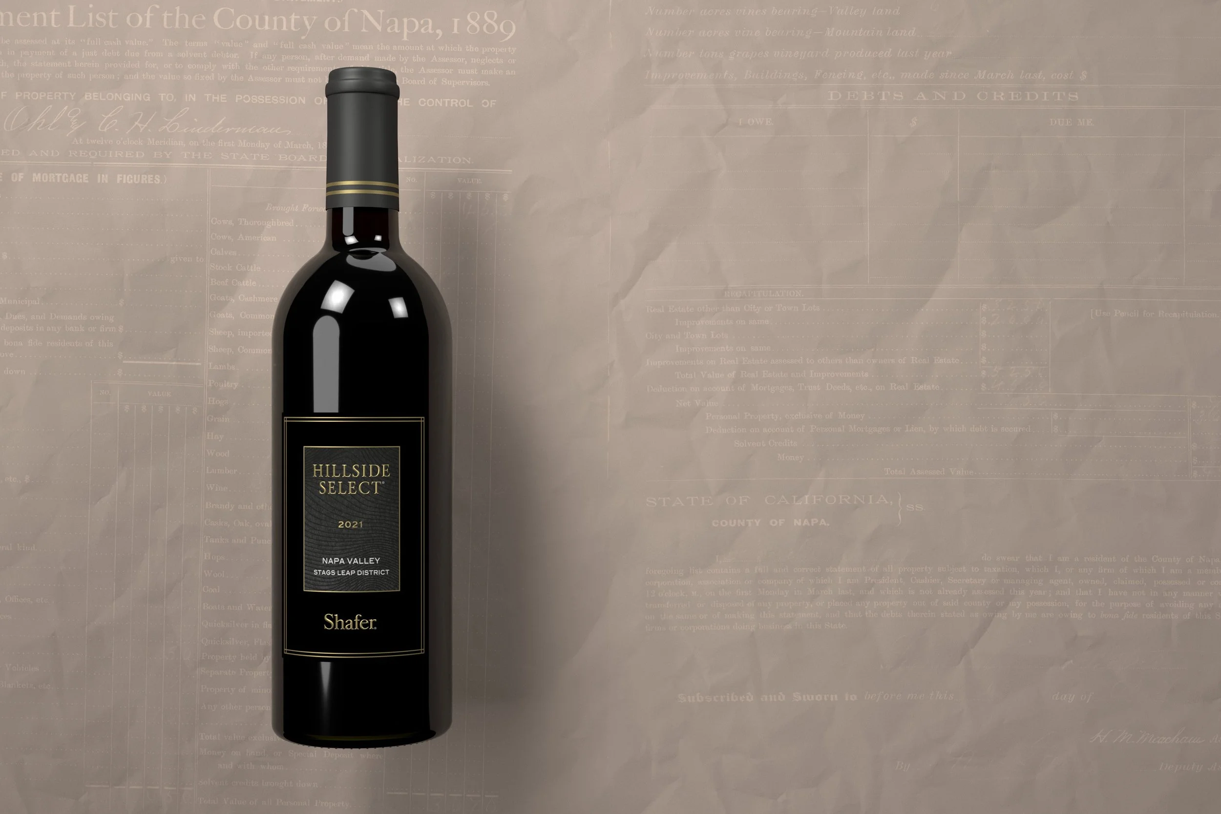 A dark wine bottle with a black label reading "Hillside Select 2021 Napa Valley Stags Leap District" in gold letters. The background is a blurred, faintly visible document or ledger.