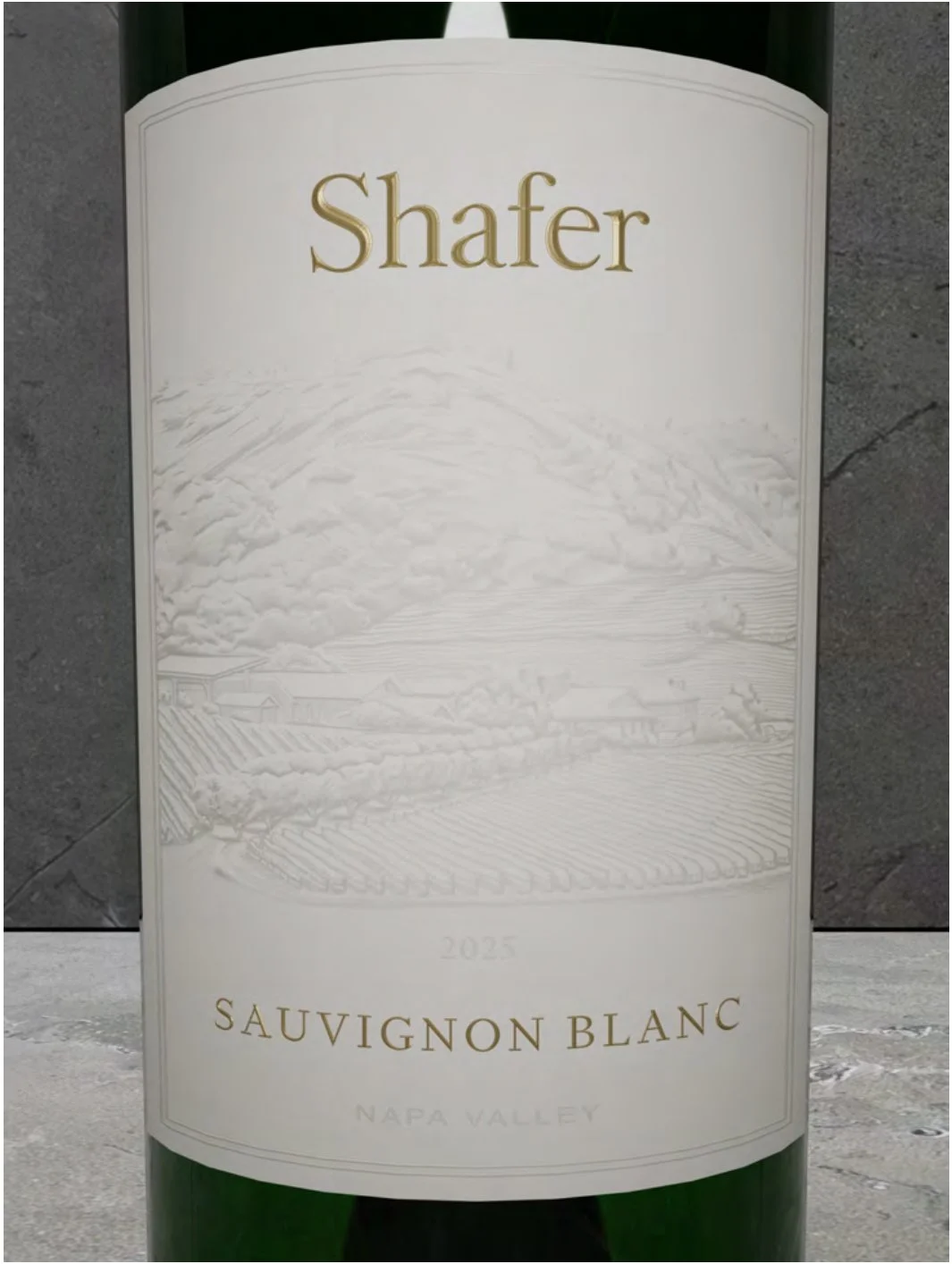 Close-up of a wine bottle label for Shafer Sauvignon Blanc from Napa Valley, vintage 2025, with a subtle embossed landscape illustration.