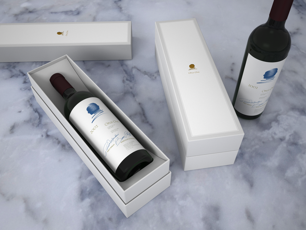 A bottle of wine in a white gift box and another bottle of wine outside the box on a marble surface.