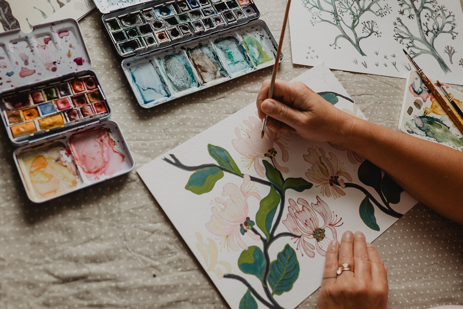 Surface pattern designer Ieva Rudzite of Nordic Duck painting original botanical and floral motifs by hand, inspired by nature, folk art and heritage design.