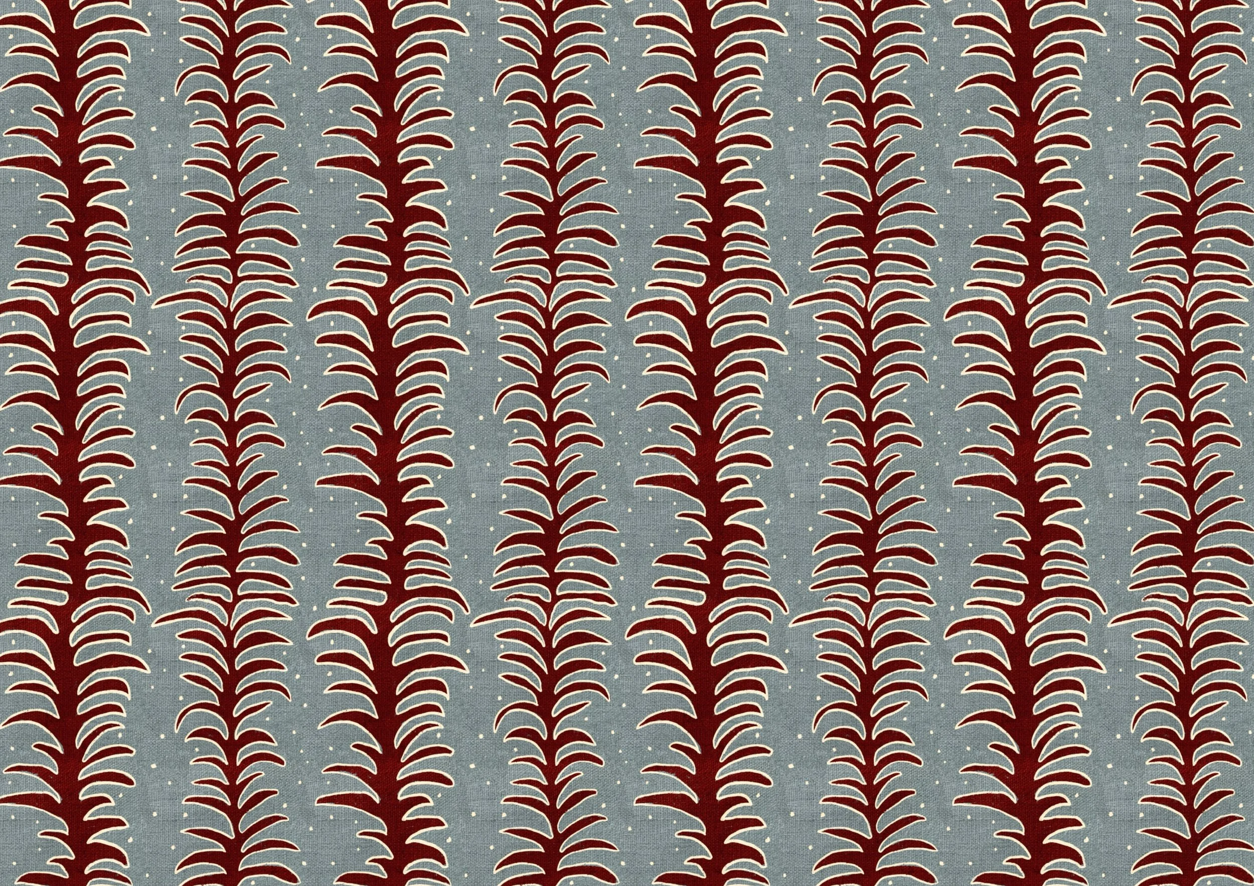 Close-up pattern of red and white stylized fiery plant shapes on a blue textured background with small white dots.