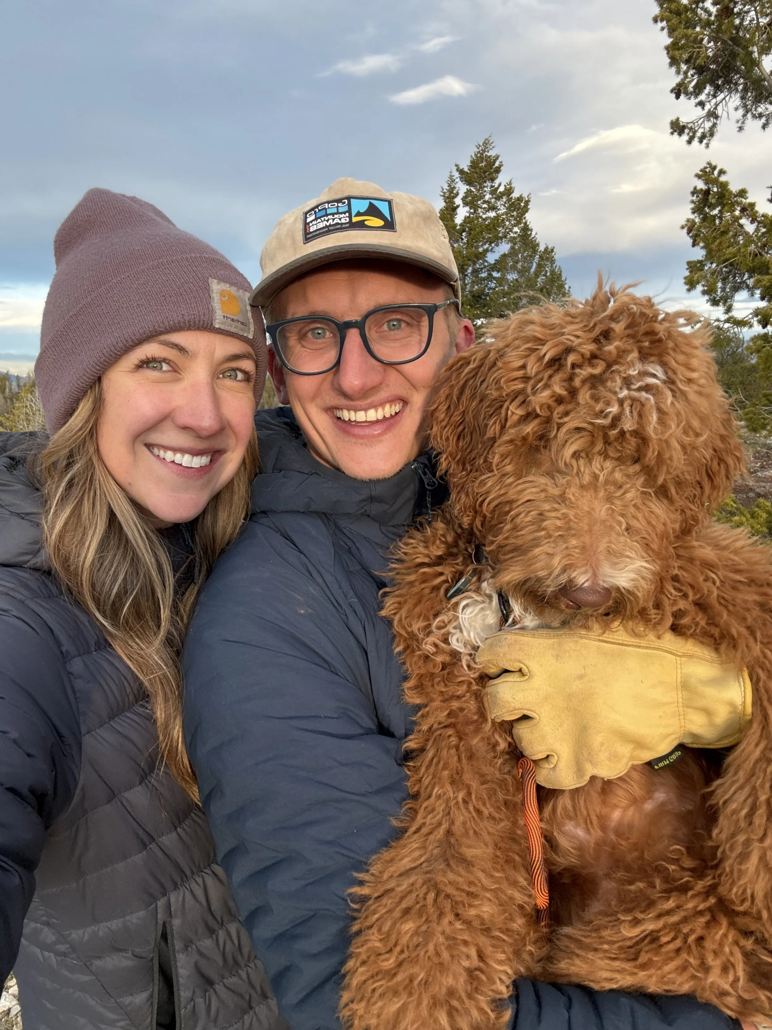 Stephanie Hands outdoors in the Colorado mountains with her husband and their dog.