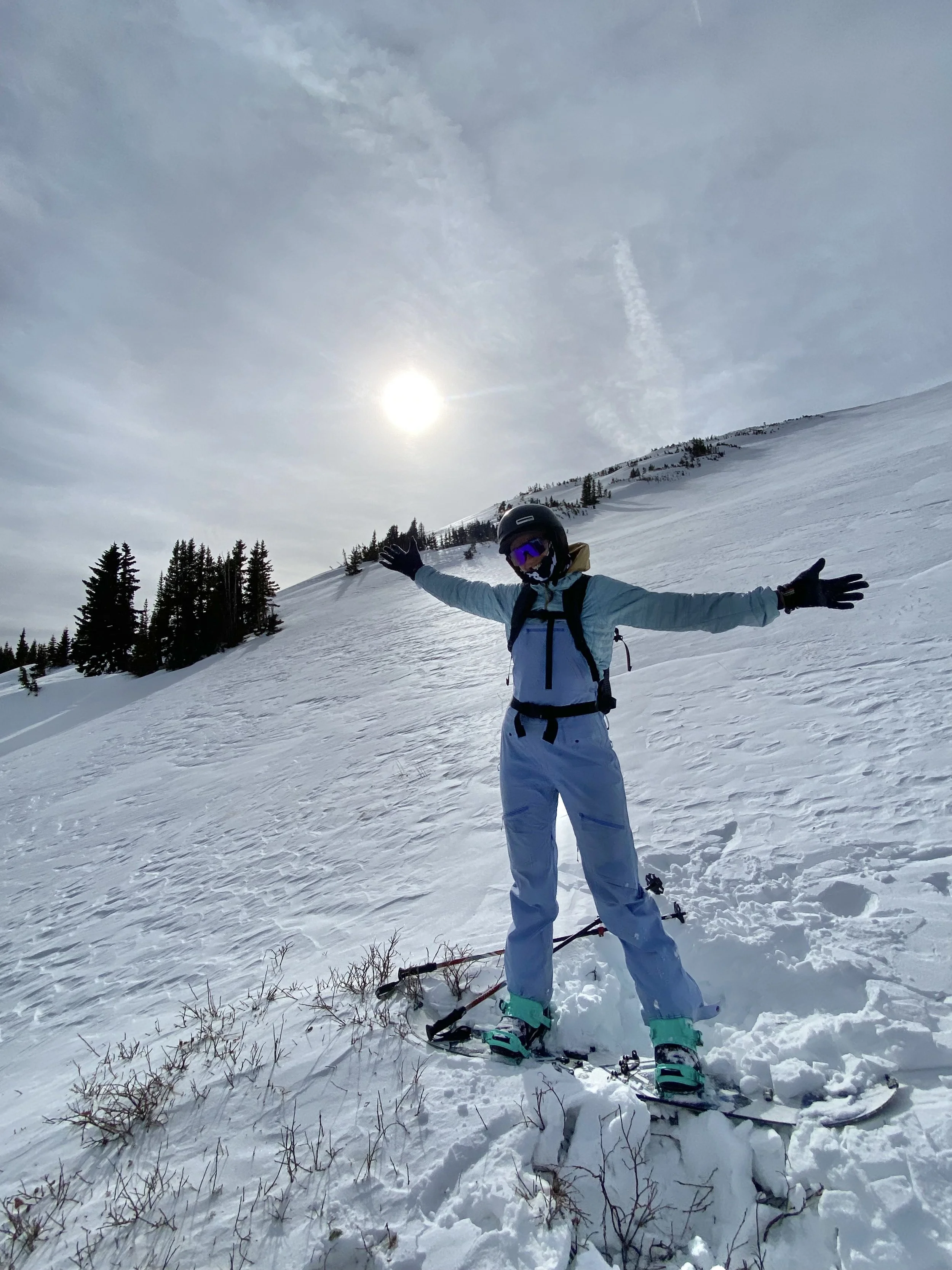 Stephanie Hands skiing in the Colorado mountains on a snowy winter day.