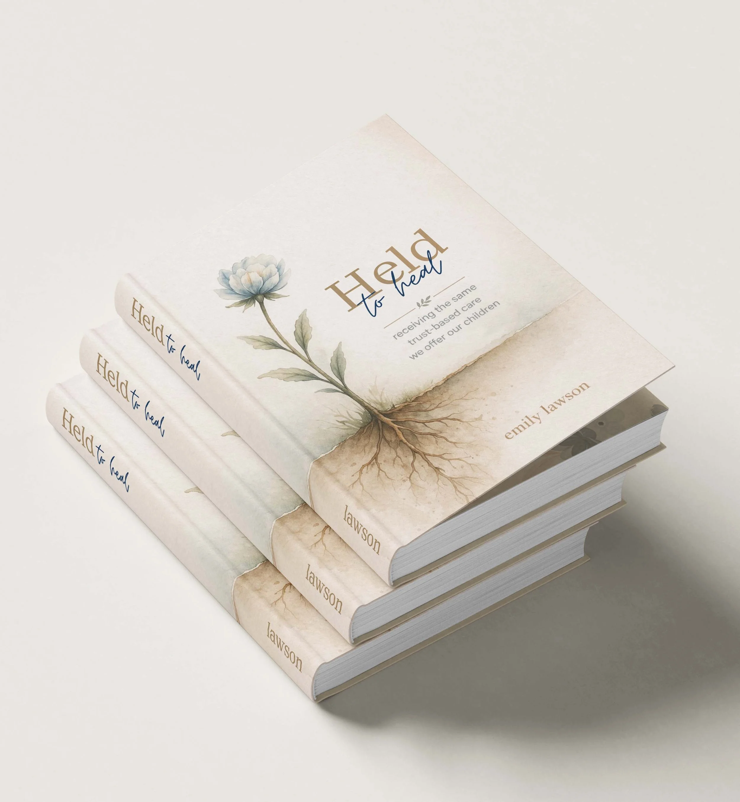 Set of multiple copies of a book titled "Held to Heal" by Emily Lawson, with a floral illustration of a flower on the cover, placed on a white surface