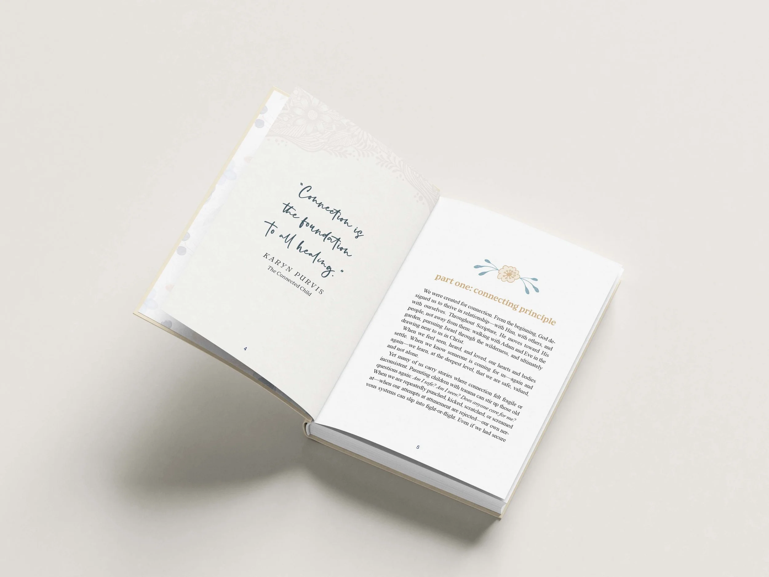 Open book with text, showing a quote on the left page and part of a chapter heading on the right page, resting on a light surface.