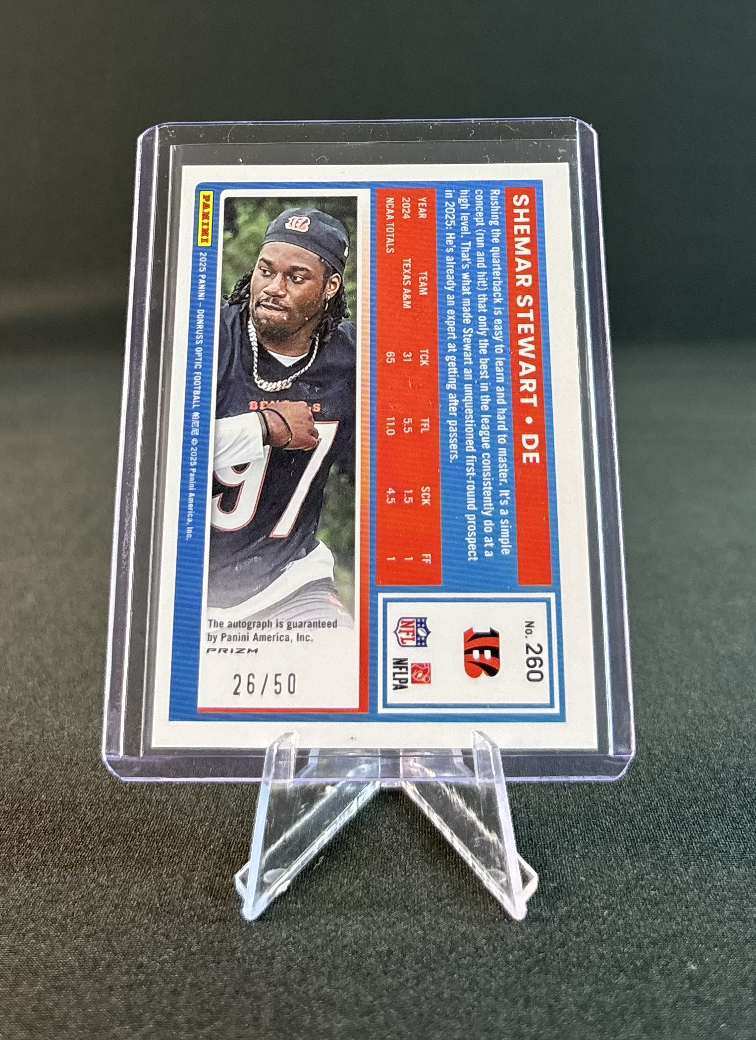 A football trading card featuring Shemar Stewart in a protective case on a black surface. The card includes his photo, name, team, and various stats.