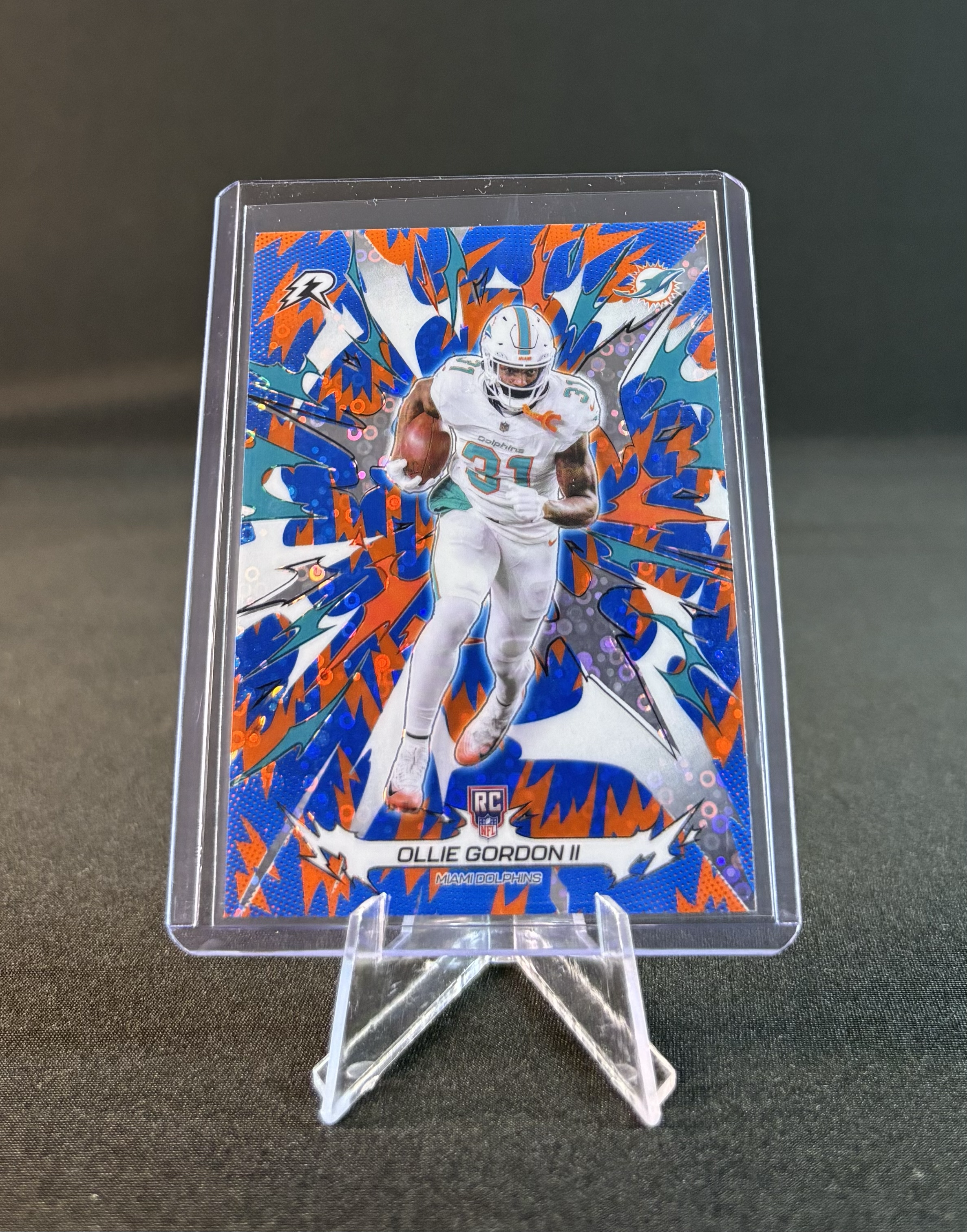 Trading card featuring Miami Dolphins player Ollie Gordon II, with a colorful, dynamic background.