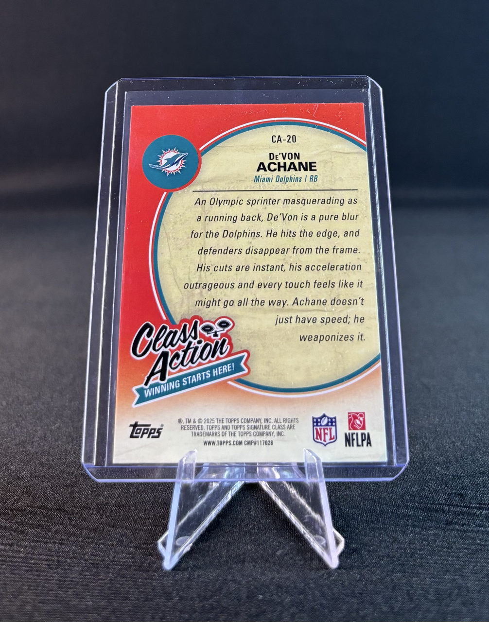A trading card featuring DeVon Achane, a Miami Dolphins running back, with a description of his playing style and skills.