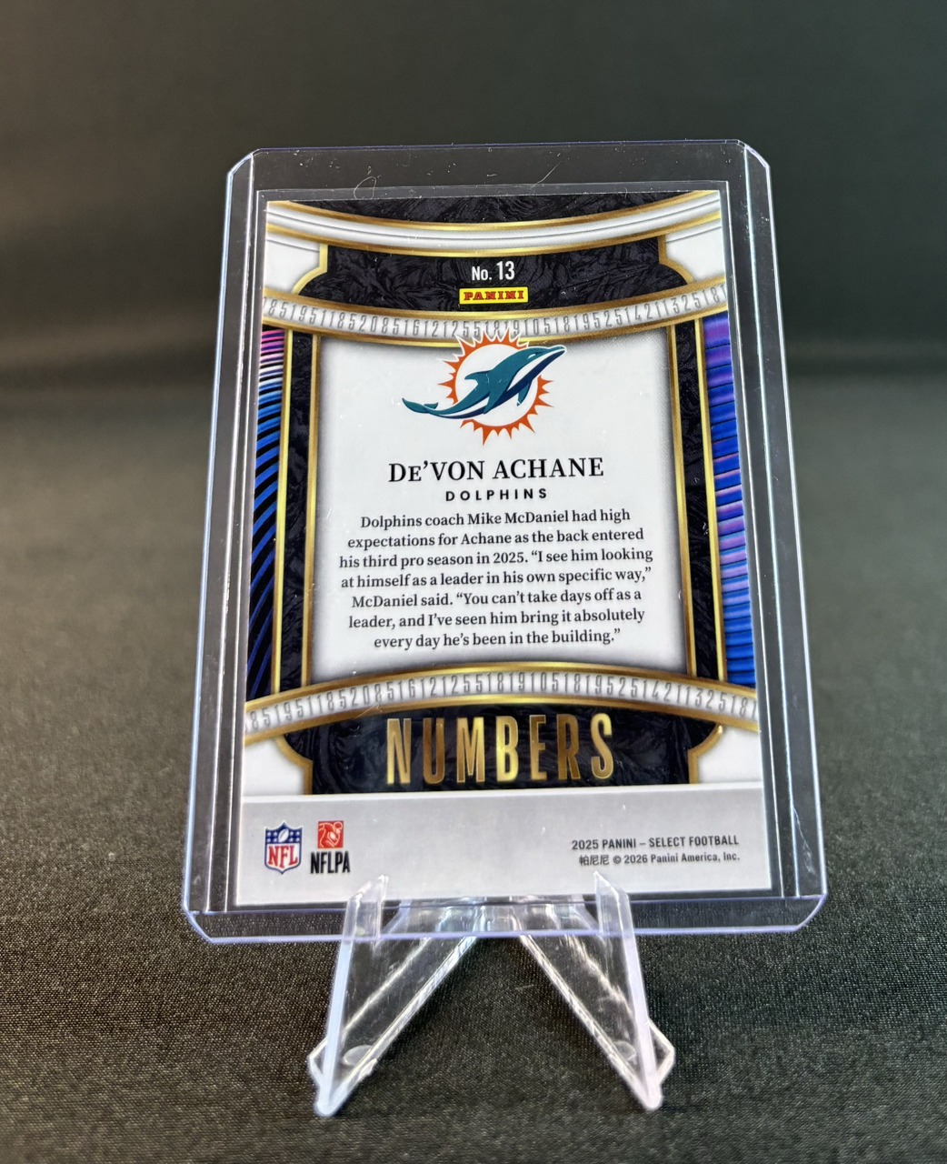 A football trading card featuring De'Von Achane, a Dolphins player, with a Dolphins logo and text about his performance.