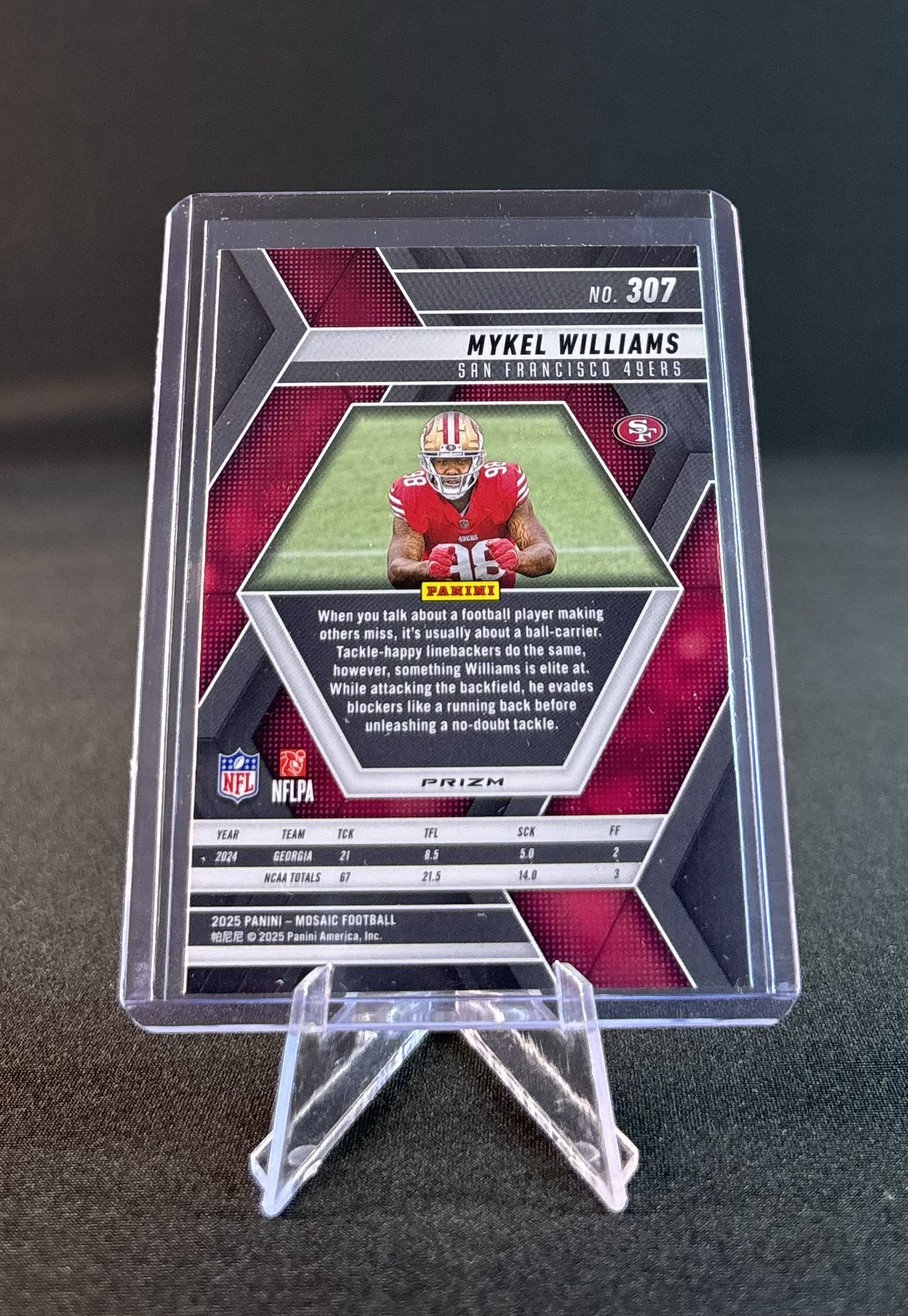 A collectible sports card of football player Mykel Williams, number 307, from the San Francisco 49ers, placed in a clear plastic display case. The card features an image of Williams in his red and gold uniform, with detailed statistics and information below.