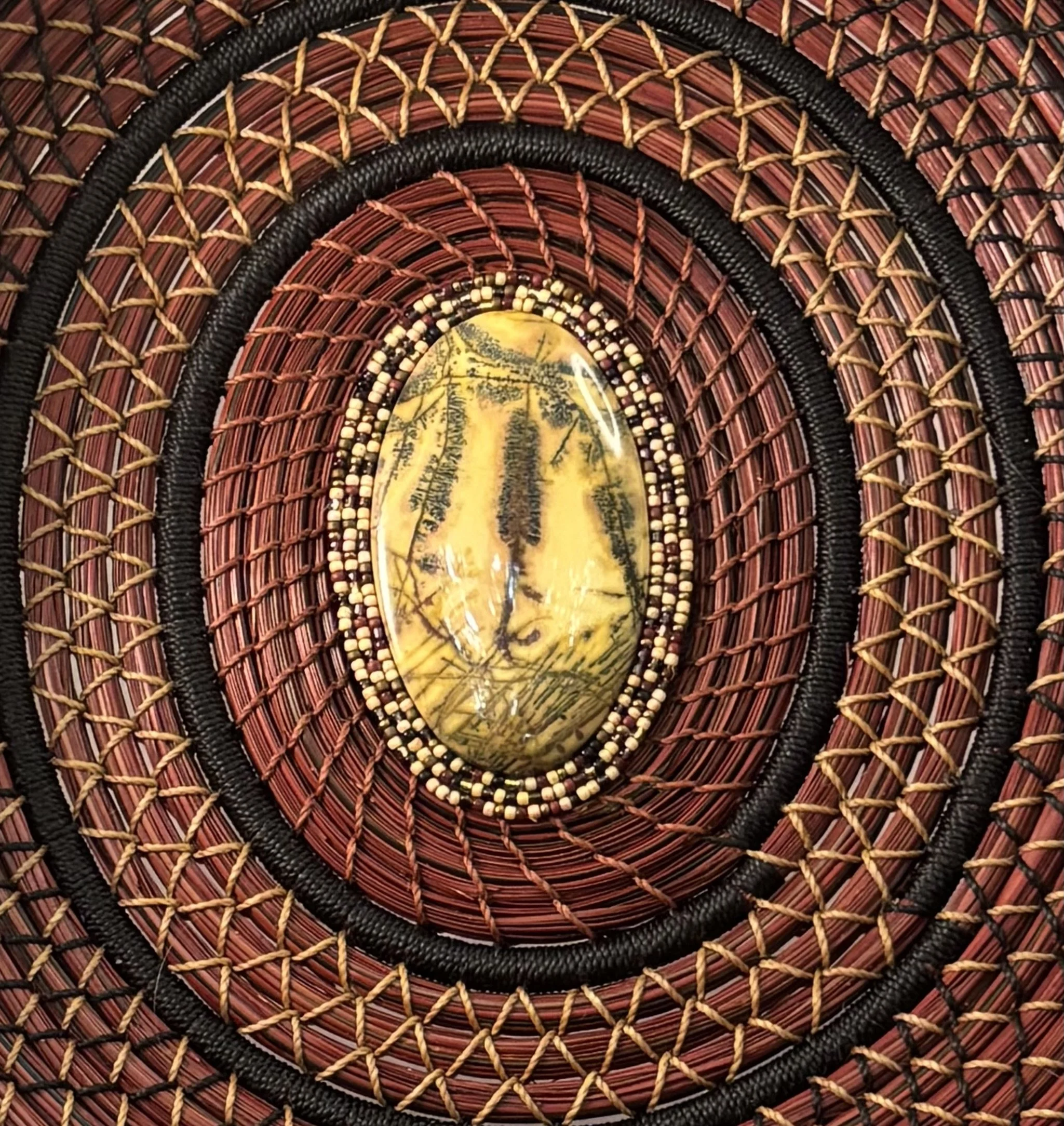 Detail of dendritic agate center with three rows of stitched seed beads