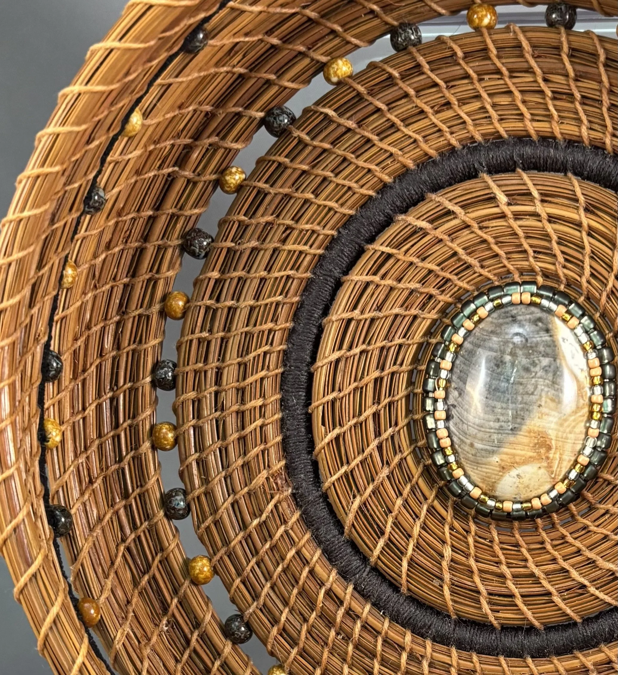 Detail of Gathering Light showing turmeric-dyed longleaf pine needles, black and yellow Picasso beads, black and yellow waxed linen thread.