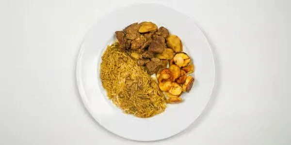 Plate of fried rice, beef, and vegetables.