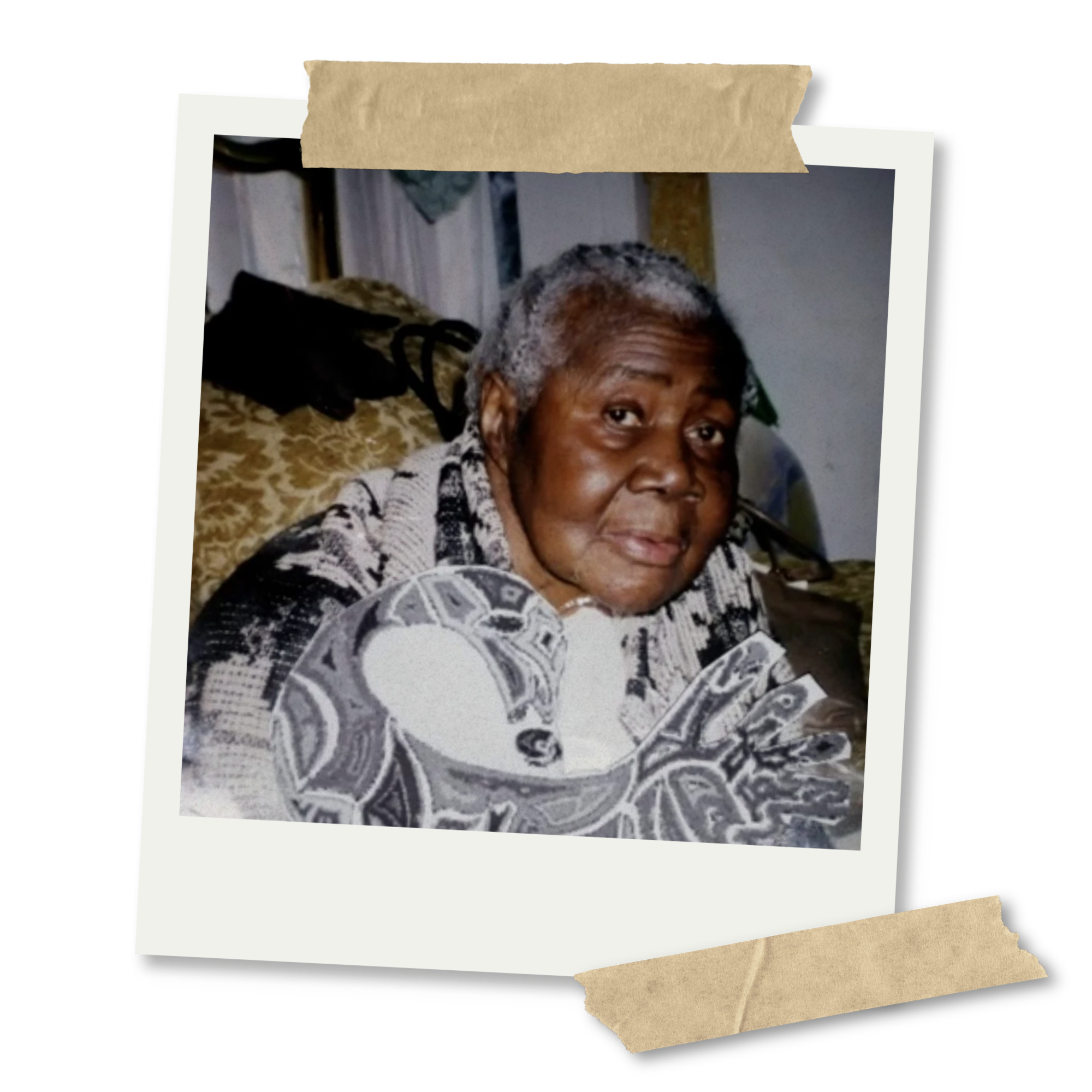 A polaroid photograph of an elderly woman with short curly gray hair, wearing a patterned jacket, and her head resting on her hand, sitting on a bed with a leopard print blanket. The photo is taped to a black background with beige tape on top and bottom.