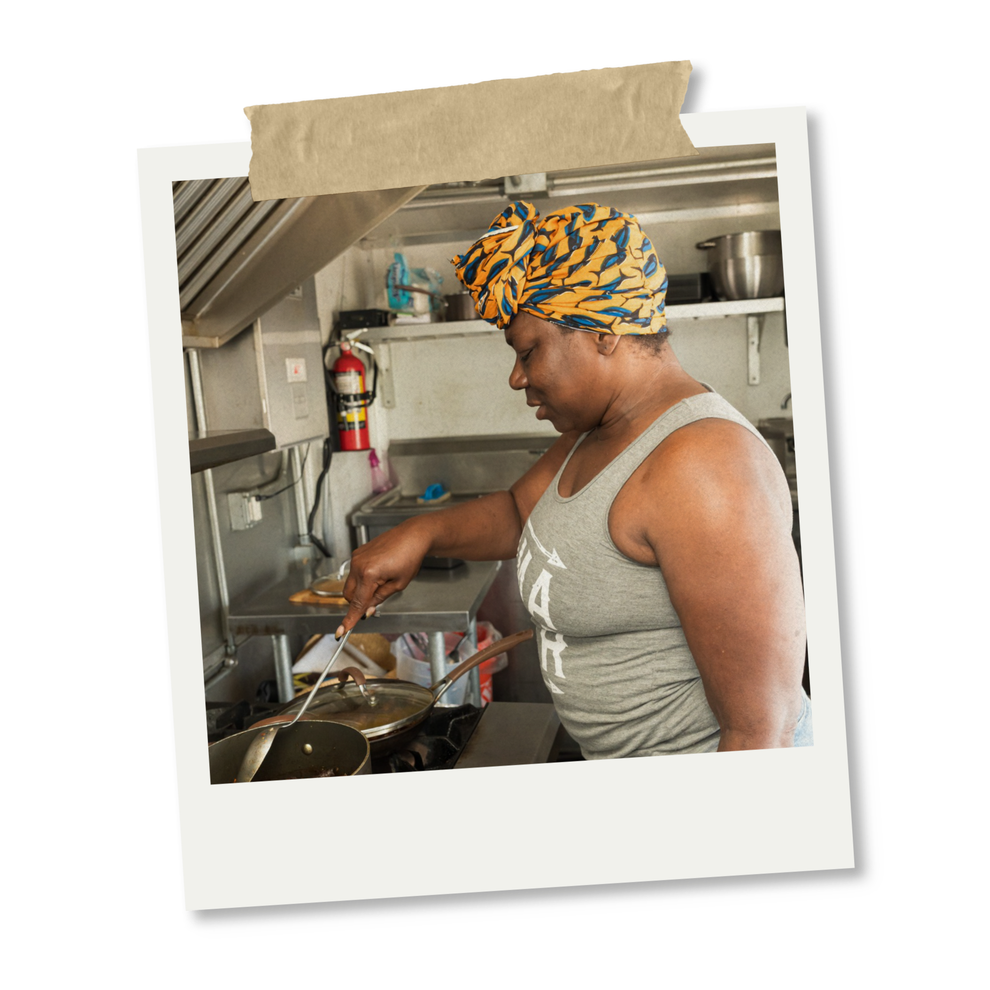 A woman wearing a colorful headwrap cook in a commercial kitchen, stirring a pot on the stove.