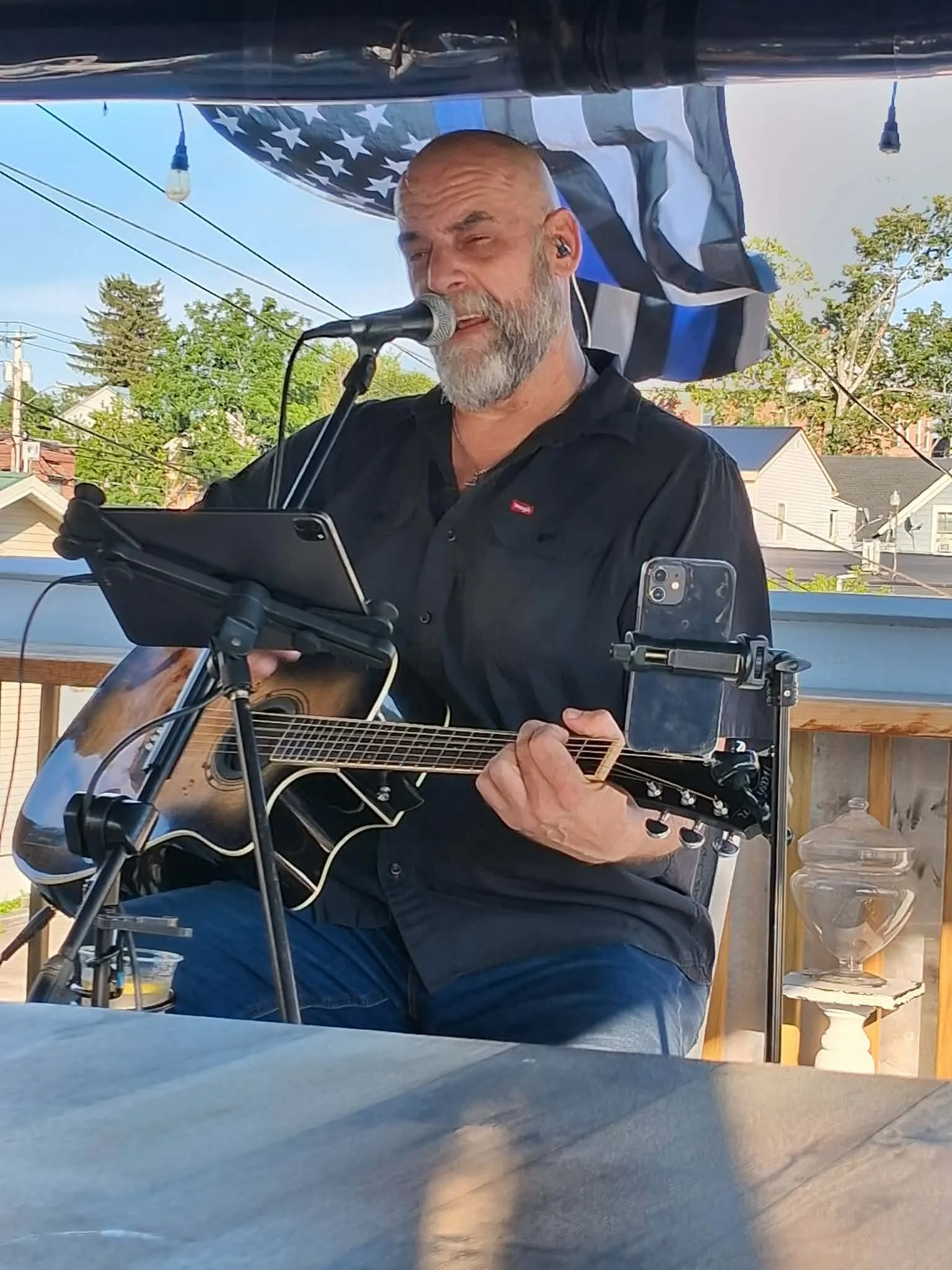 Larry Holly performing acoustic music with his current short beard
