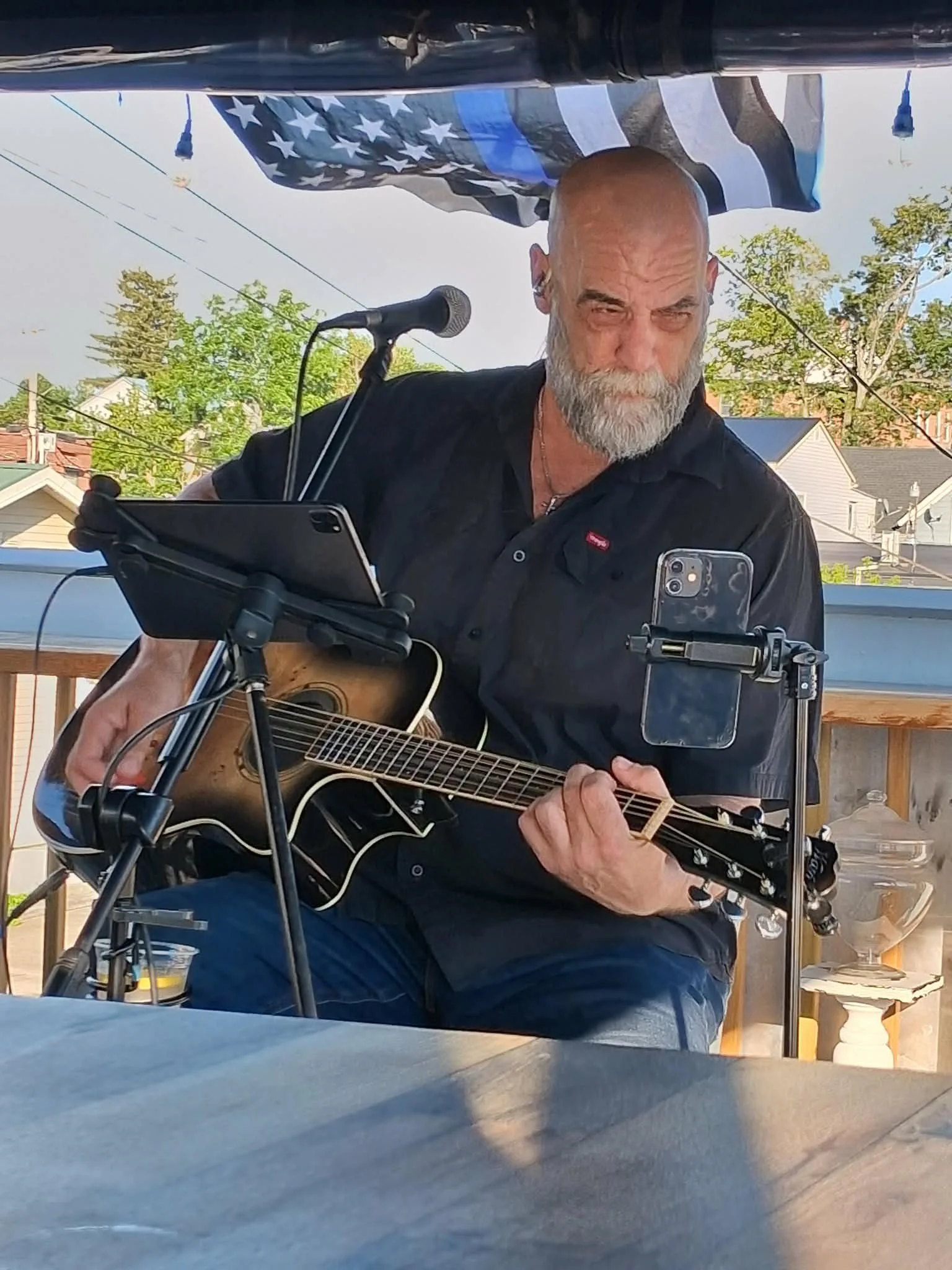 Larry Holly performing acoustic music outdoors