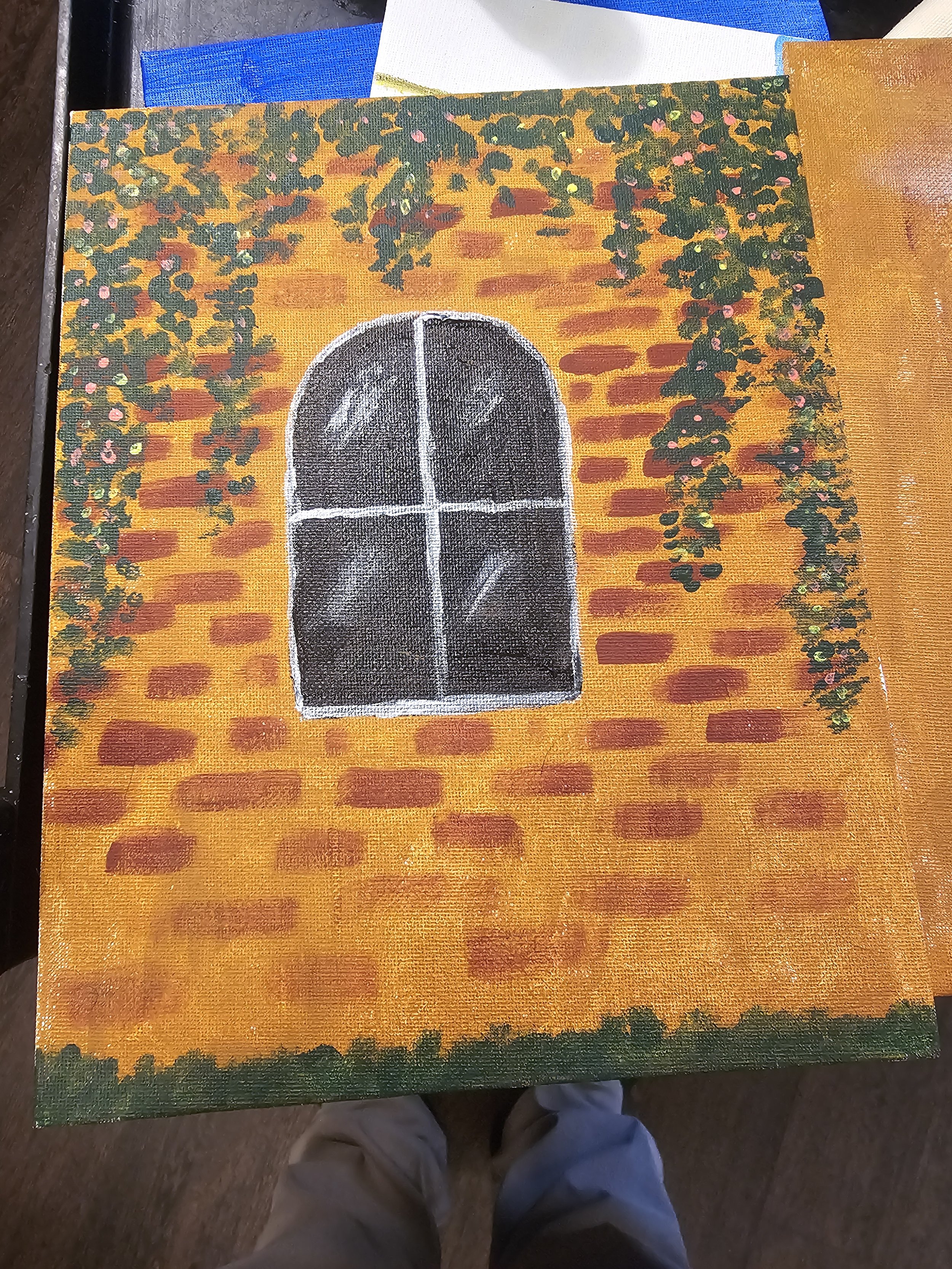 Painting of a black window with white crossbars on an orange brick wall background, surrounded by hanging green vines with pink flowers at the top and bottom edges.