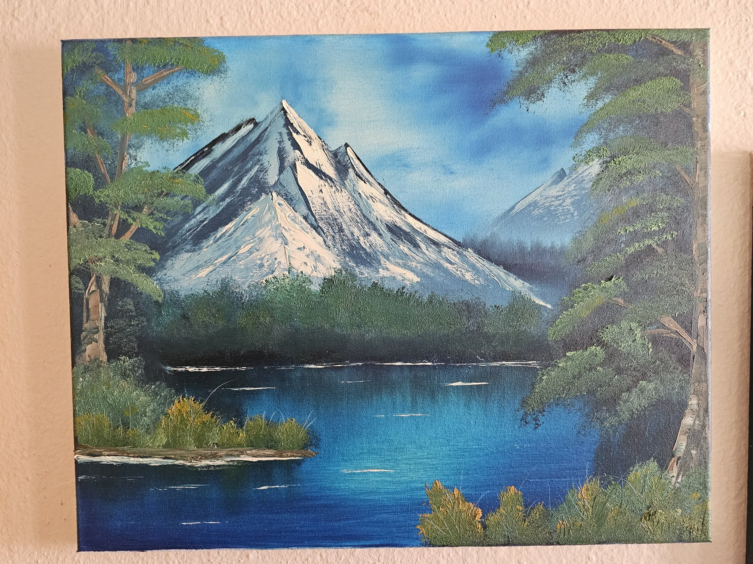 Painting of a mountain landscape with snow-capped peaks, green trees, and a blue sky.