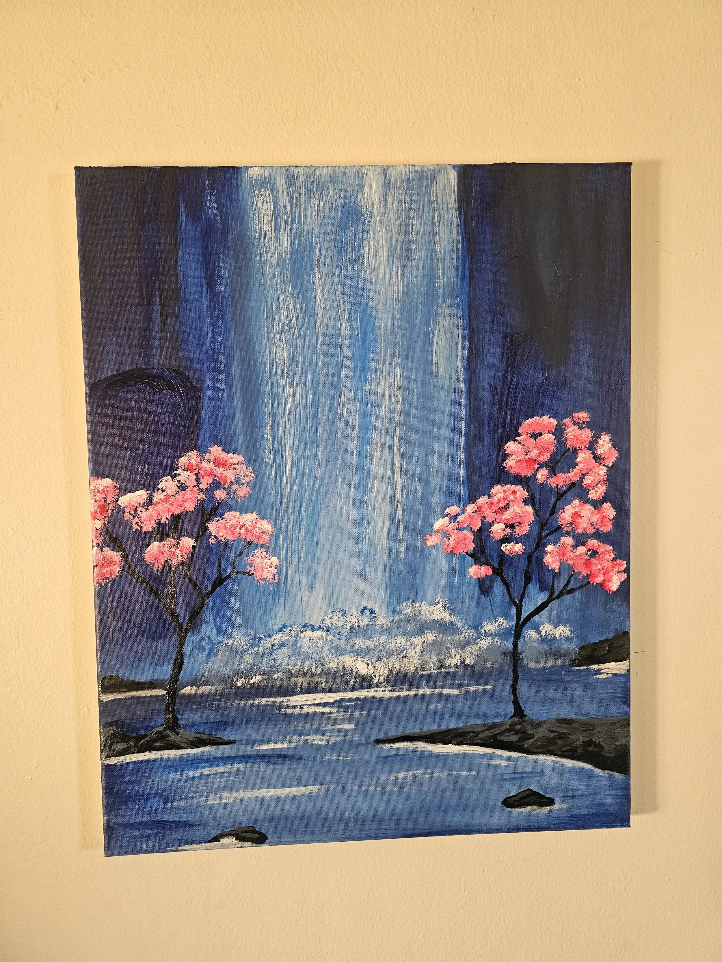 A painting of a waterfall with two pink cherry blossom trees on either side, a rocky shore, and a blue sky.