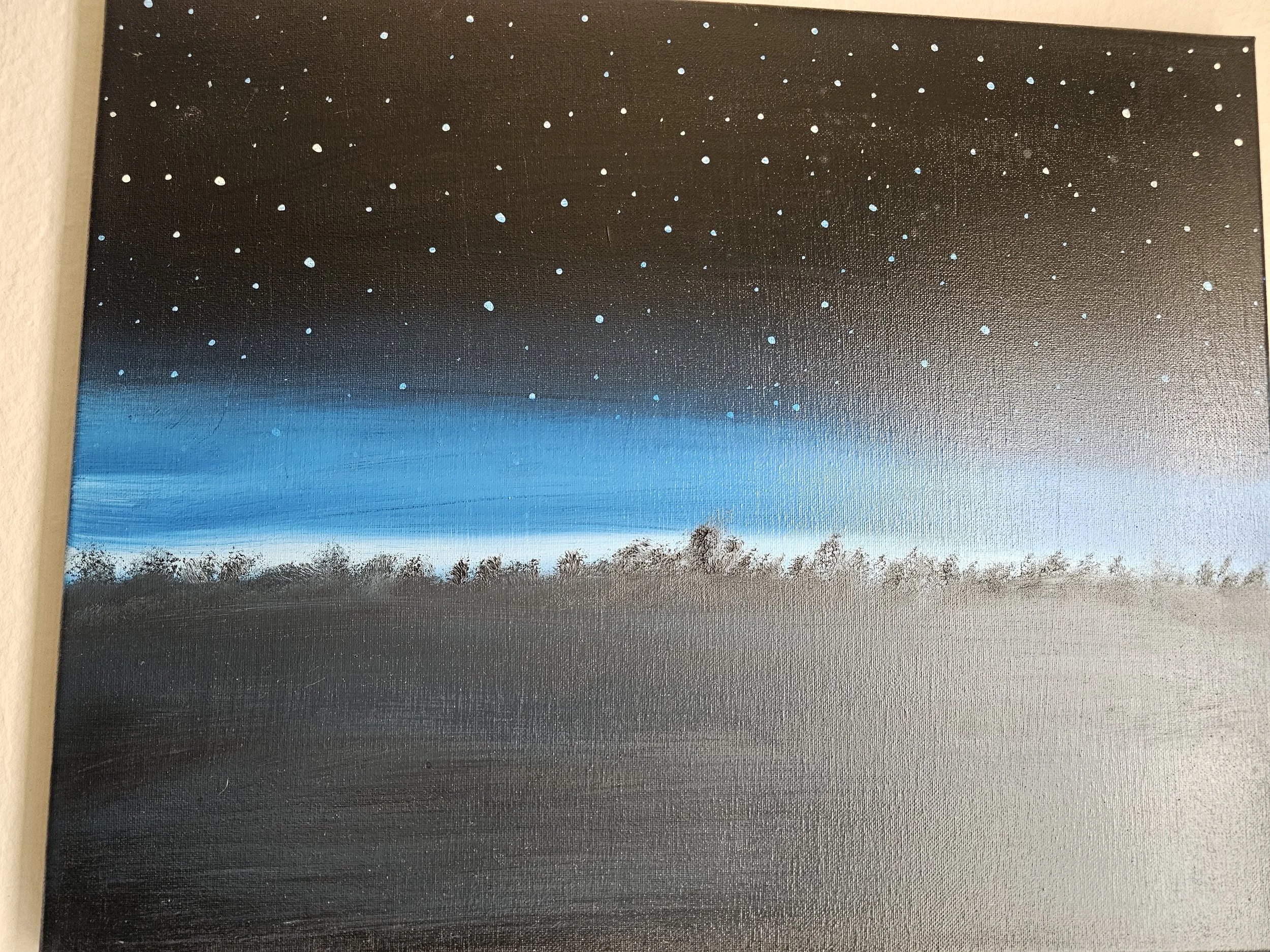 A painting depicting the night sky with numerous small white and light blue dots representing stars, against a dark background that transitions from black at the top to deep blue at the bottom, with some trees visible at the bottom edge.