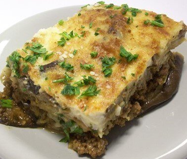 A serving of Greek moussaka on a white plate