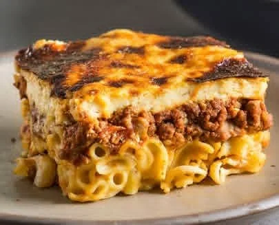 A slice of baked pastitsio, a Greek lasagna with noodles, ground meat, and cream sauce