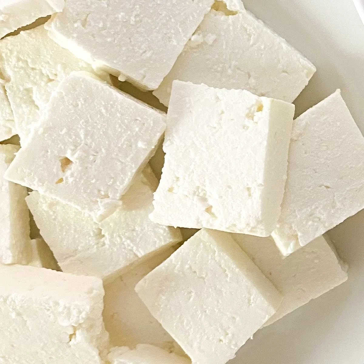 blocks of white feta piled in a dish