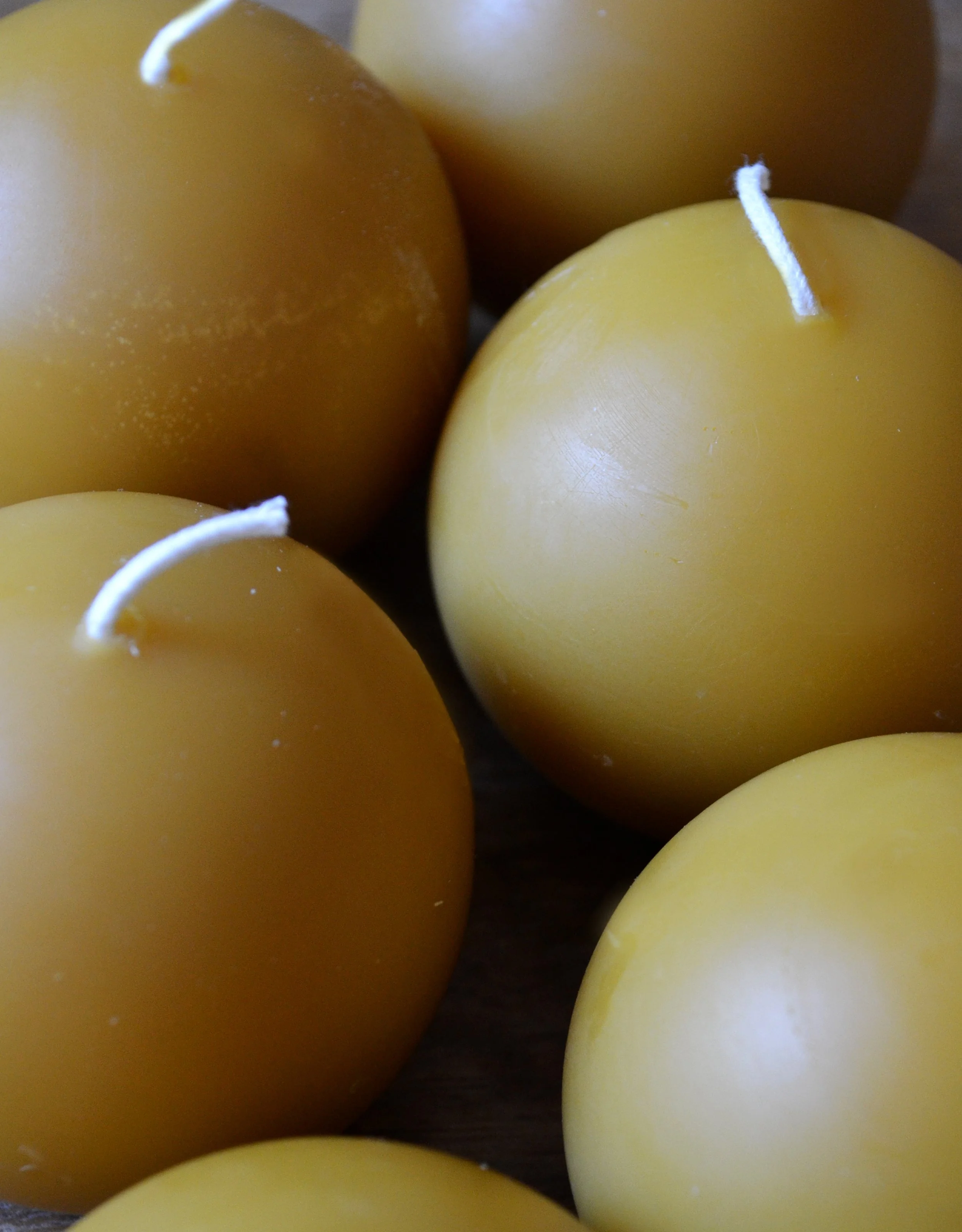 Close up of natural beeswax sphere ball candles to show natural texture. Unscented handmade candlelight for evenings and natural ambiance.