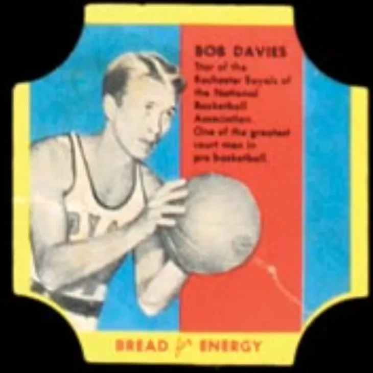 Vintage basketball card featuring Bob Davies in a shooting stance, holding a basketball, with red and blue background and yellow border, promoting 'Bread Energy'.