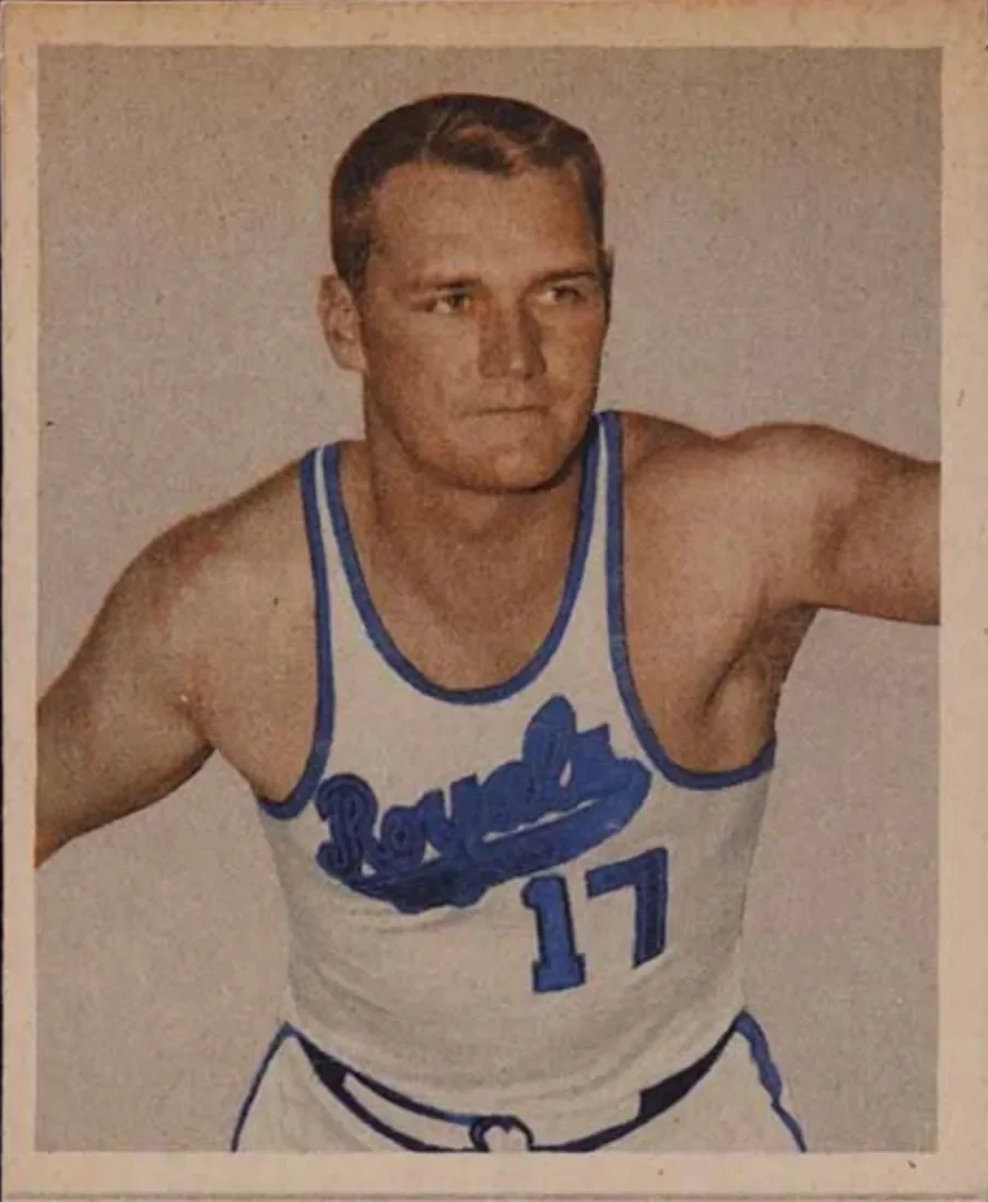 A vintage basketball player portrait of a man wearing a white and blue uniform with the number 17, posing against a neutral background.
