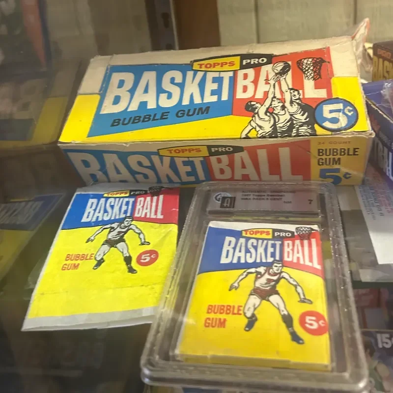 Vintage Topps Pro Basketball bubble gum card set with cartoon basketball players, in a display case and packaging, priced at 5 cents.