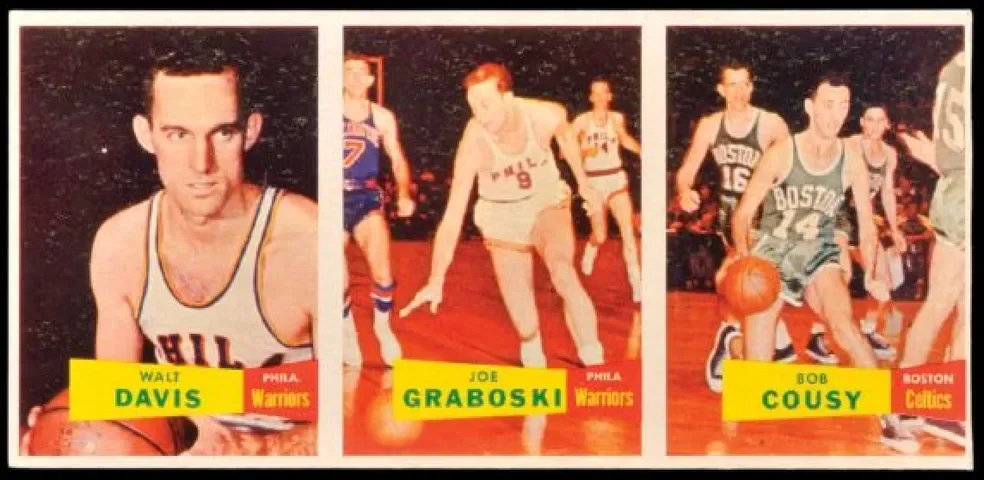 Vintage basketball trading card features three players from the 1950s or 1960s. The first player is Walt Davis from the Philadelphia Warriors, holding a basketball. The second player is Joe Graboski from the Philadelphia Warriors, reaching for the ball on a court. The third player is Bob Cousy from the Boston Celtics, dribbling a basketball on a court. Each player's name and team affiliation are displayed on yellow labels.
