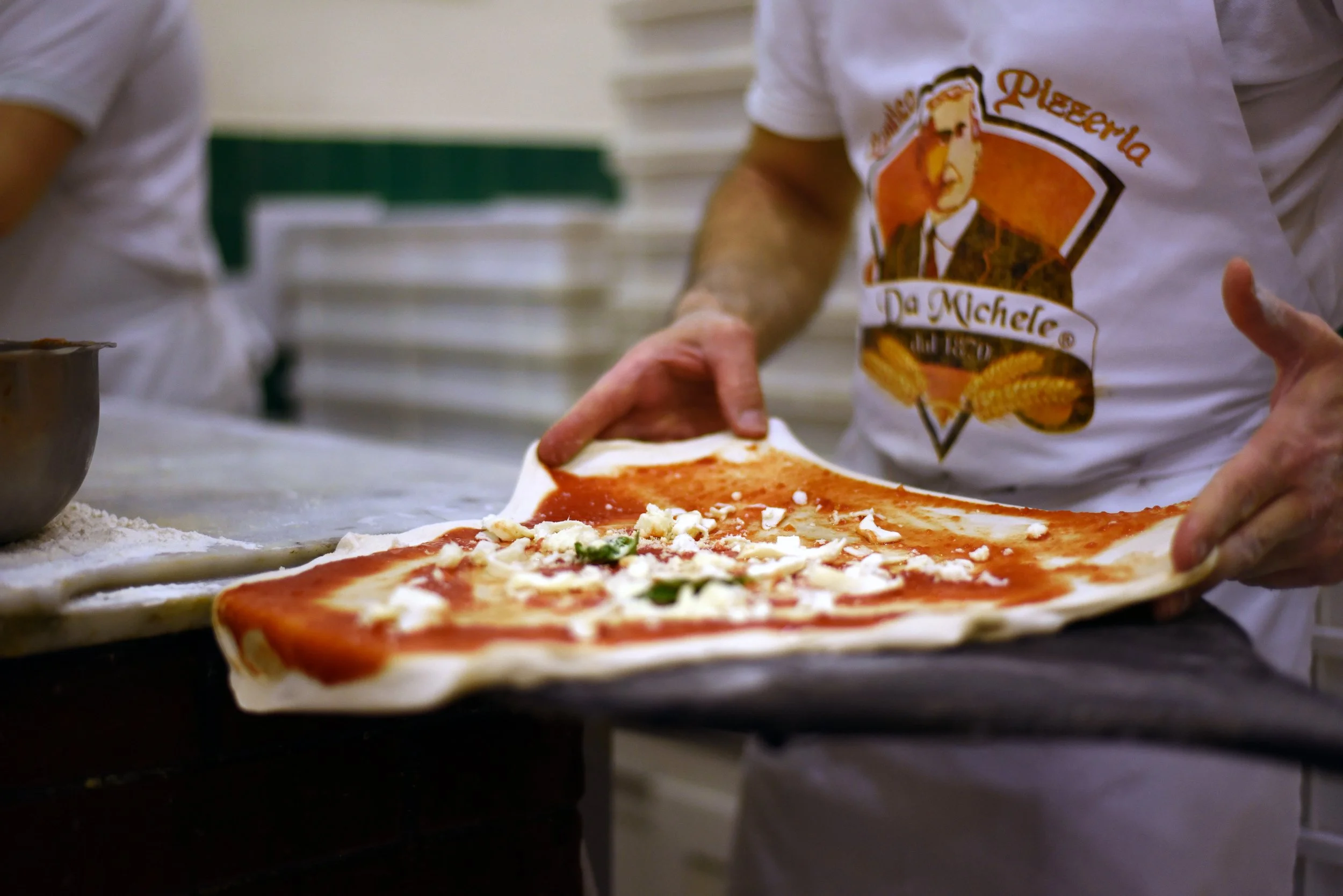Traditional Neapolitan pizza being handmade at L'Antica Pizzeria da Michele in Naples.