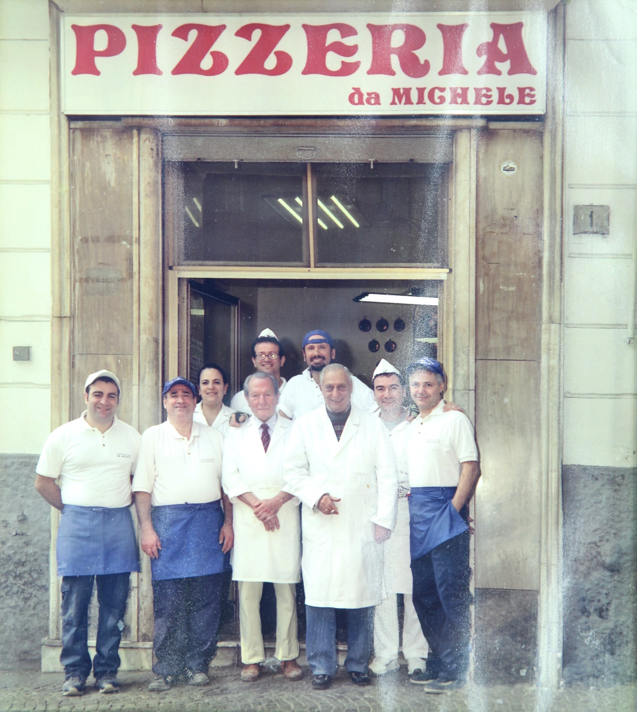 Historic group of Pizzaioli outside L'Antica Pizzeria da Michele in Naples.