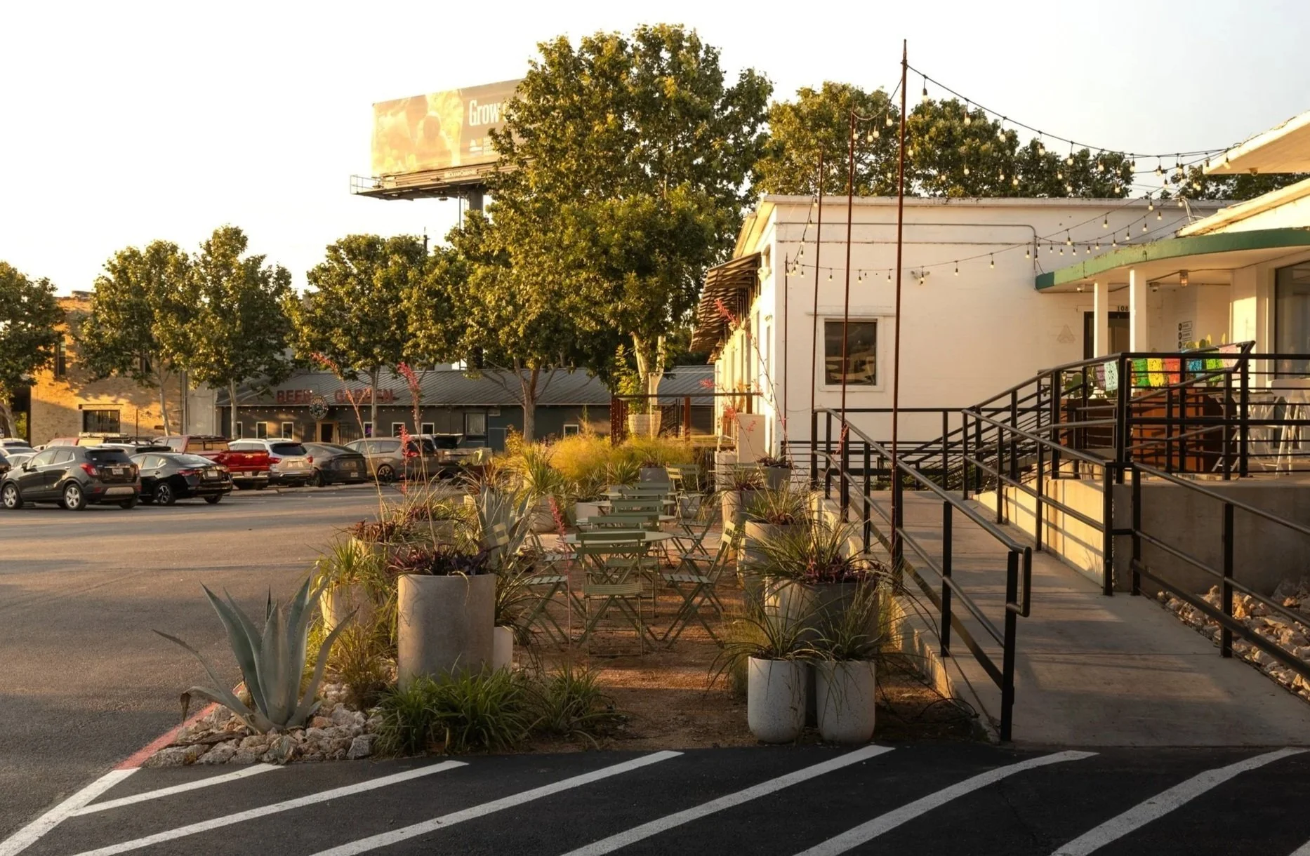 Newly installed commercial landscape with planting beds and paving