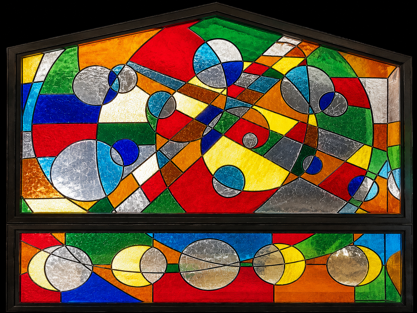Colorful stained glass window featuring abstract geometric shapes and circular patterns.