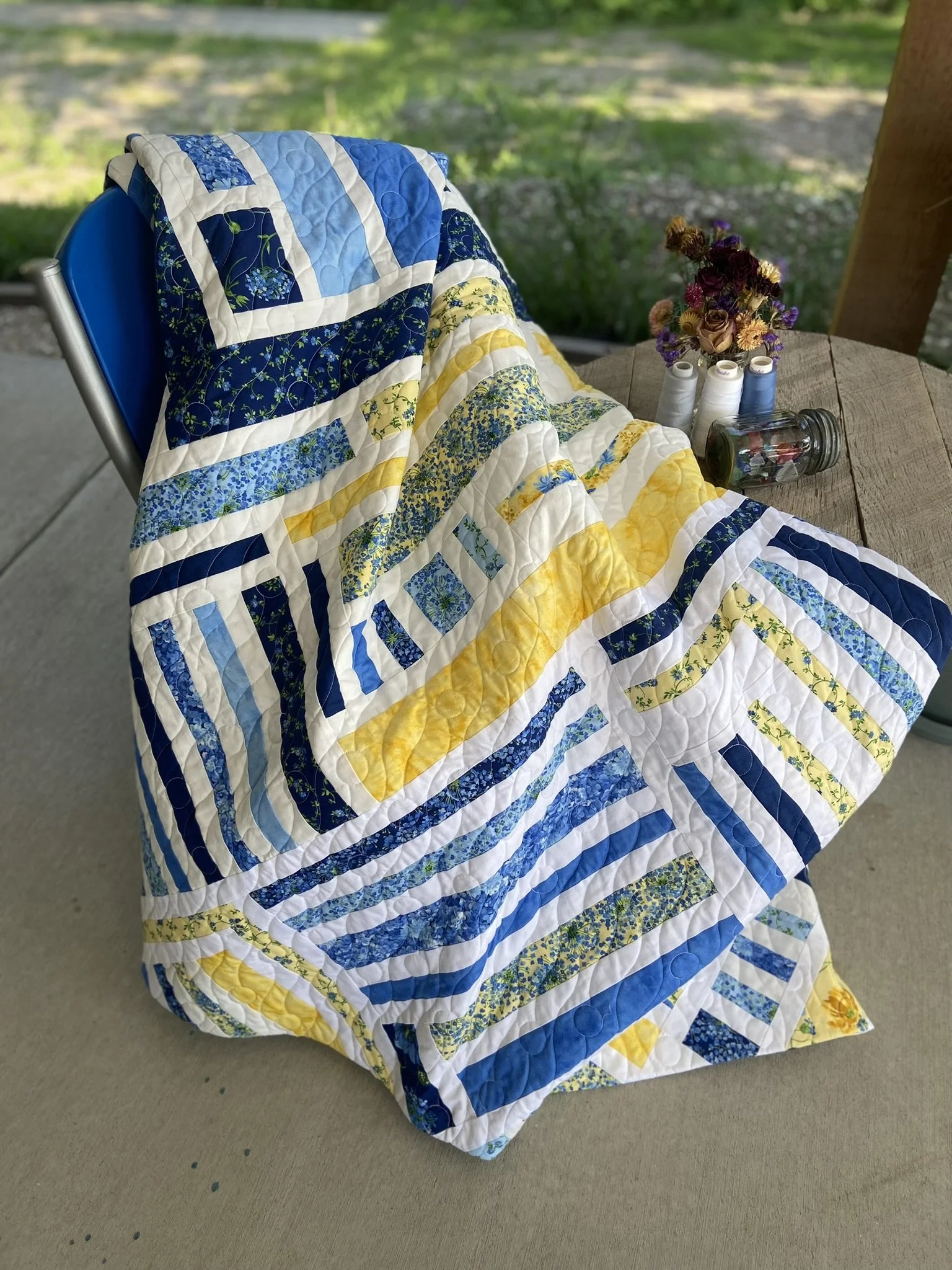 Colorful patchwork quilt with blue, yellow, and white patterns