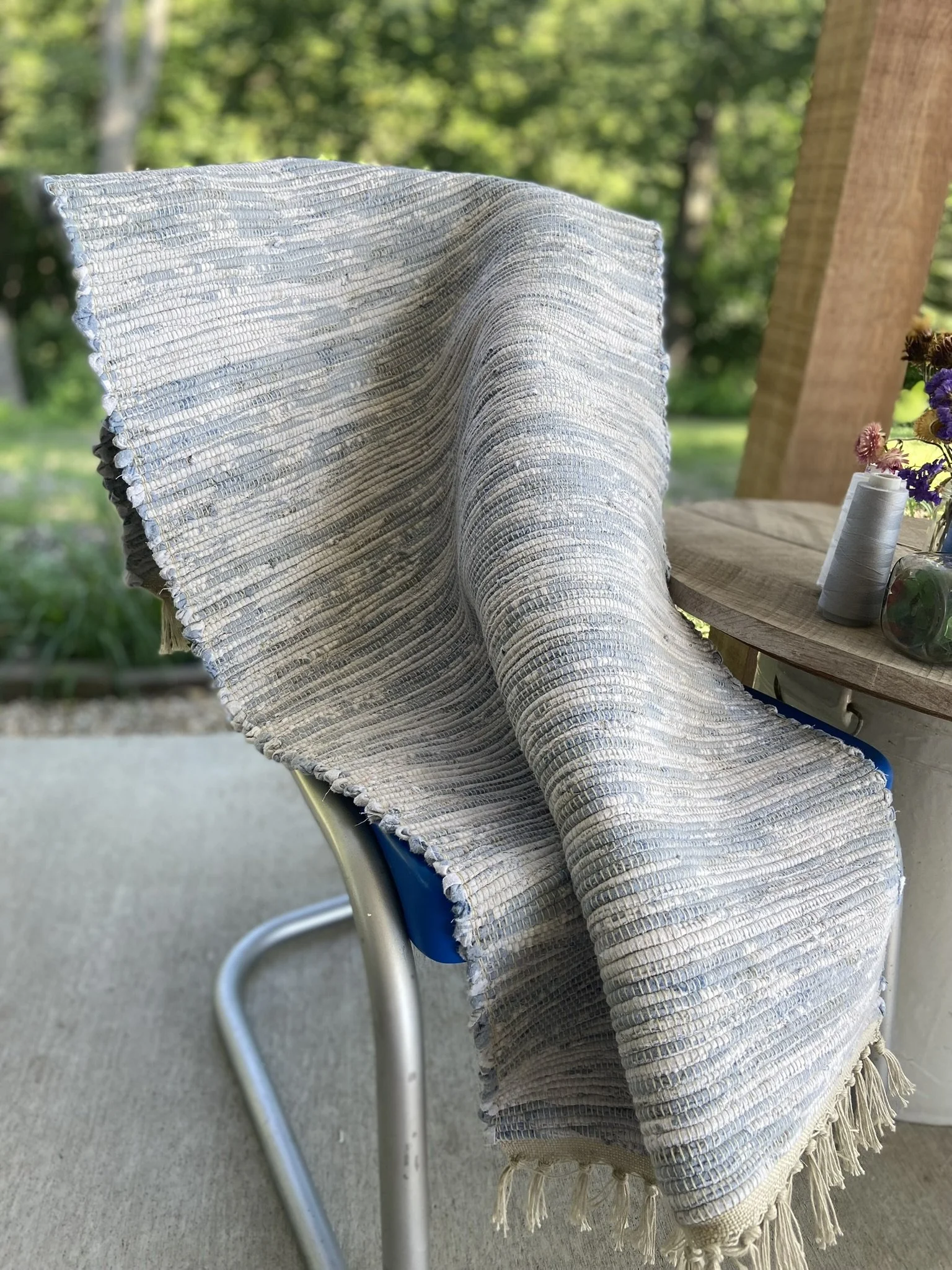 Handwoven rug with fringe ends.