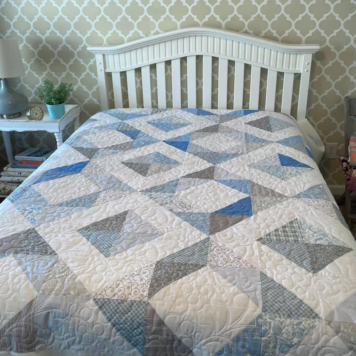 patchwork quilt featuring shades of blue, gray, and white. 
