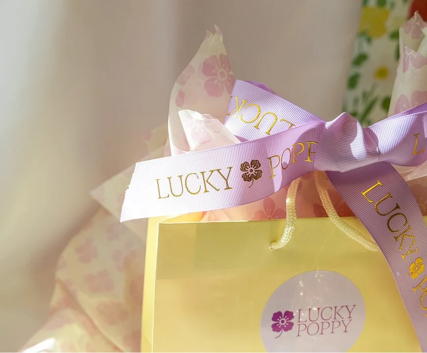 Branded gift bags and ribbon for Lucky Poppy