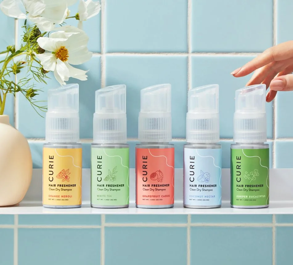 Curie dry shampoo with branded packaging illustrations