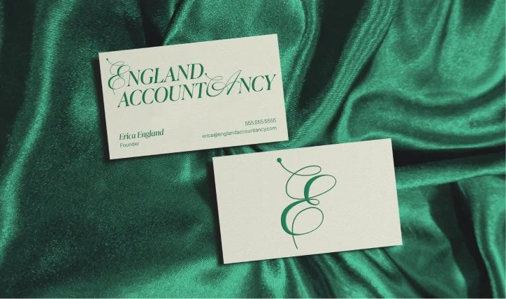 England Accountacy business card laying on emerald green velvet fabric